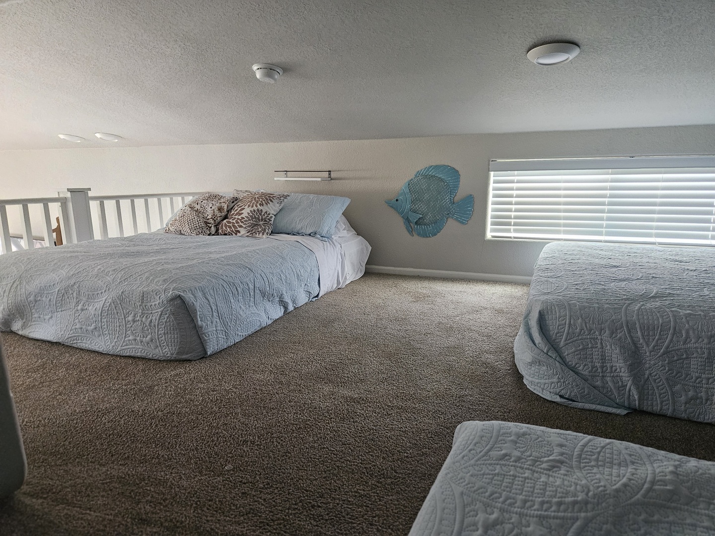 Cozy loft sleeping area in an RV rental, featuring two beds with light blue quilts.. ATHMS CCHPT 2019