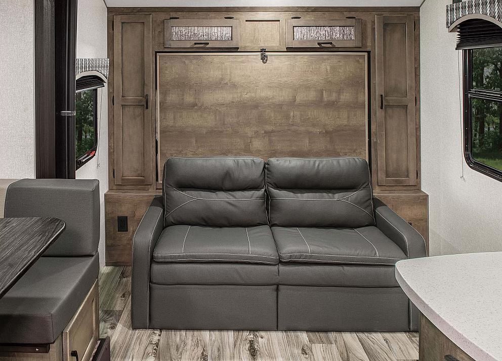 RV rental: Compact interior with a gray sofa/murphy bed system & wood cabinets. Perfect for efficient RV living.. Sonic Sonic Trailer 2022