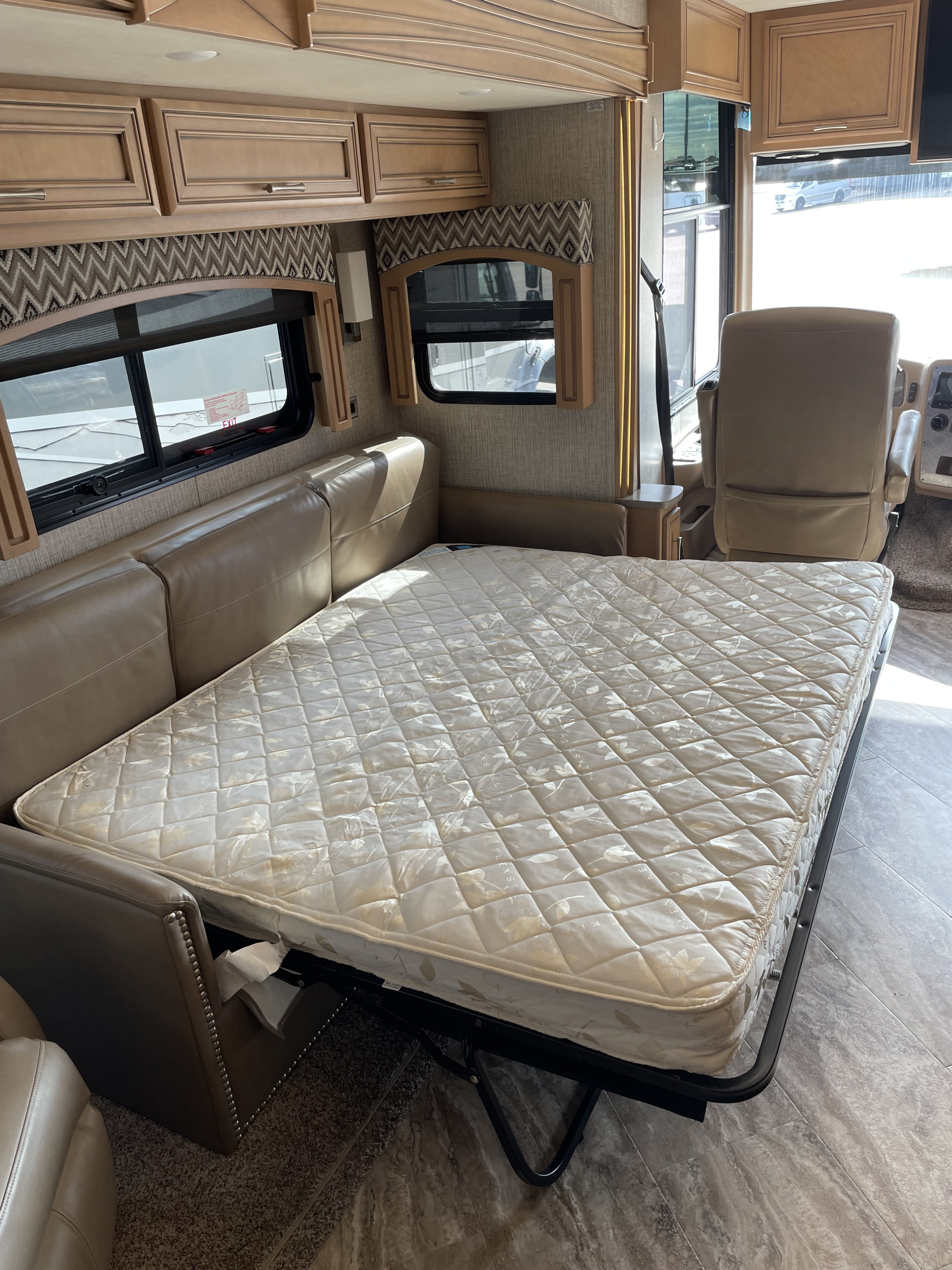 Explore this RV rental's versatile interior featuring a pull-out mattress from the couch, sleek cabinetry, and driver's area.. Canyon Star Canyon Star Motorhome 2020