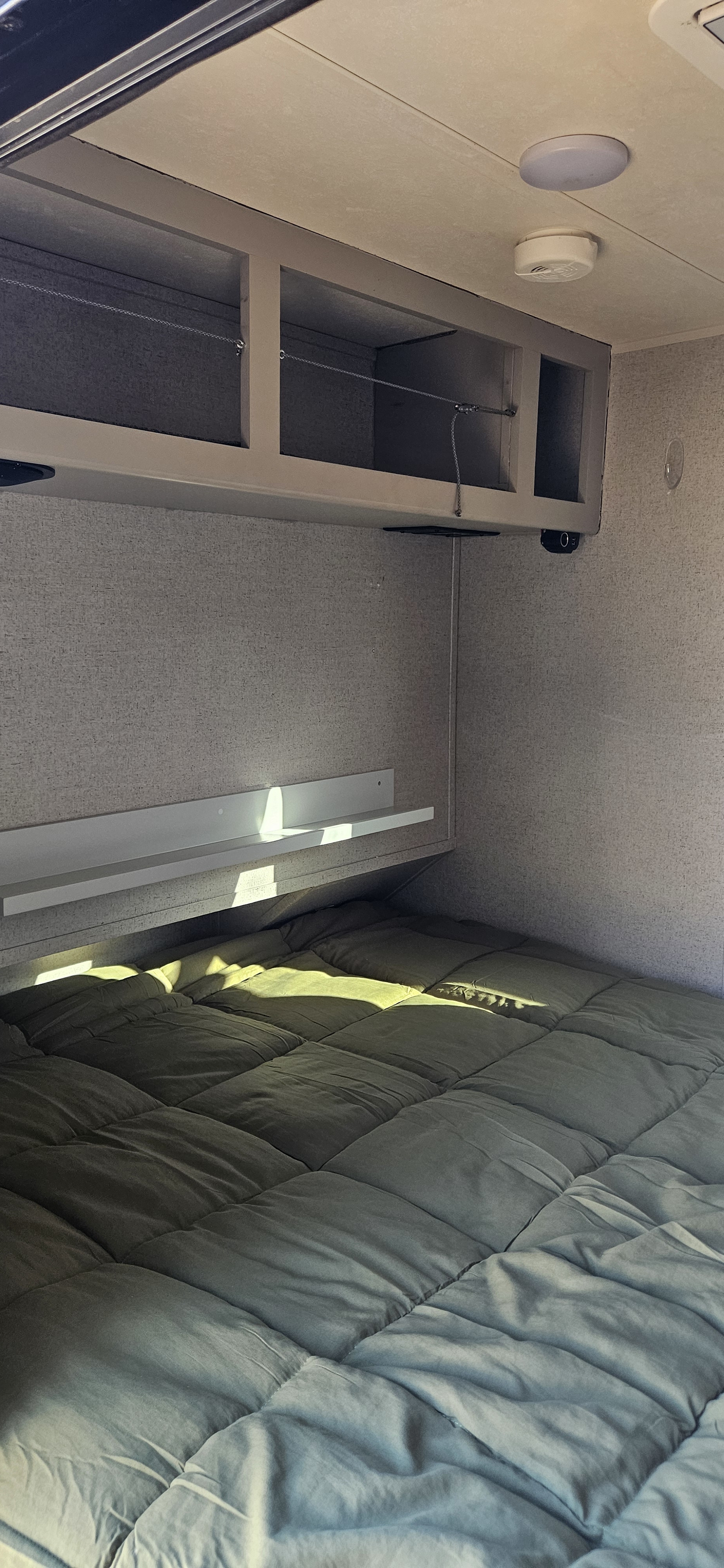 Cozy RV rental bedroom with ample storage and a comfortable bed, ready for your next adventure.. Forest River GeoPro 12RK 2017