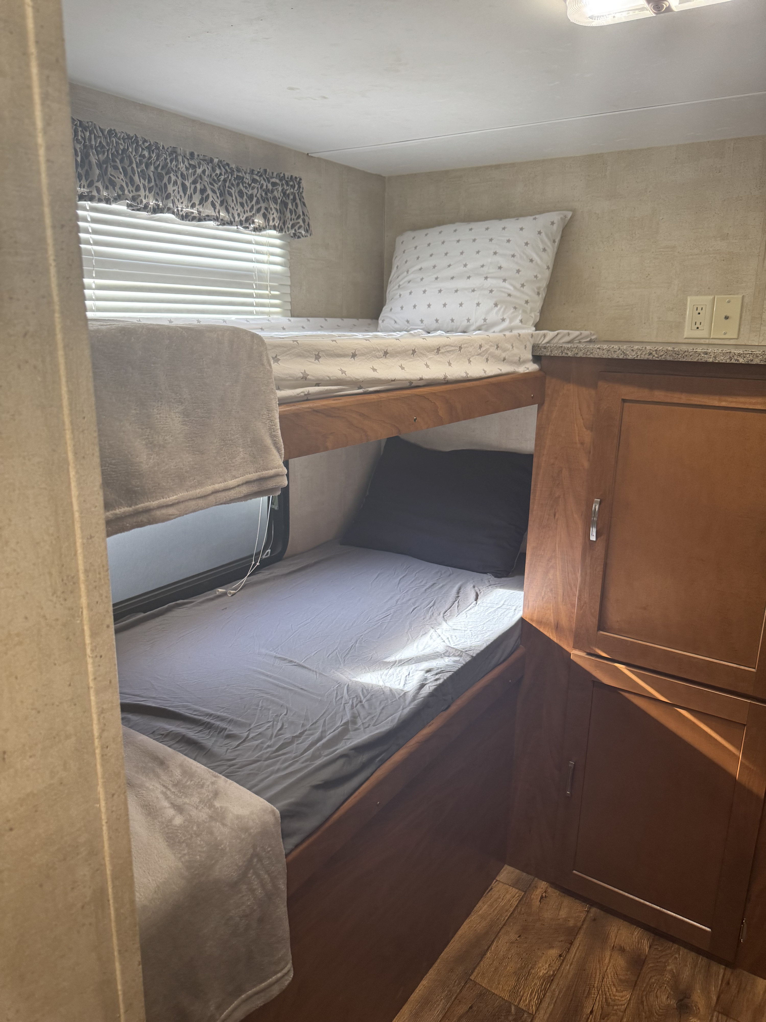 RV rental bunk beds with cozy bedding and natural light.. Keystone RV Passport Grand Touring 2014