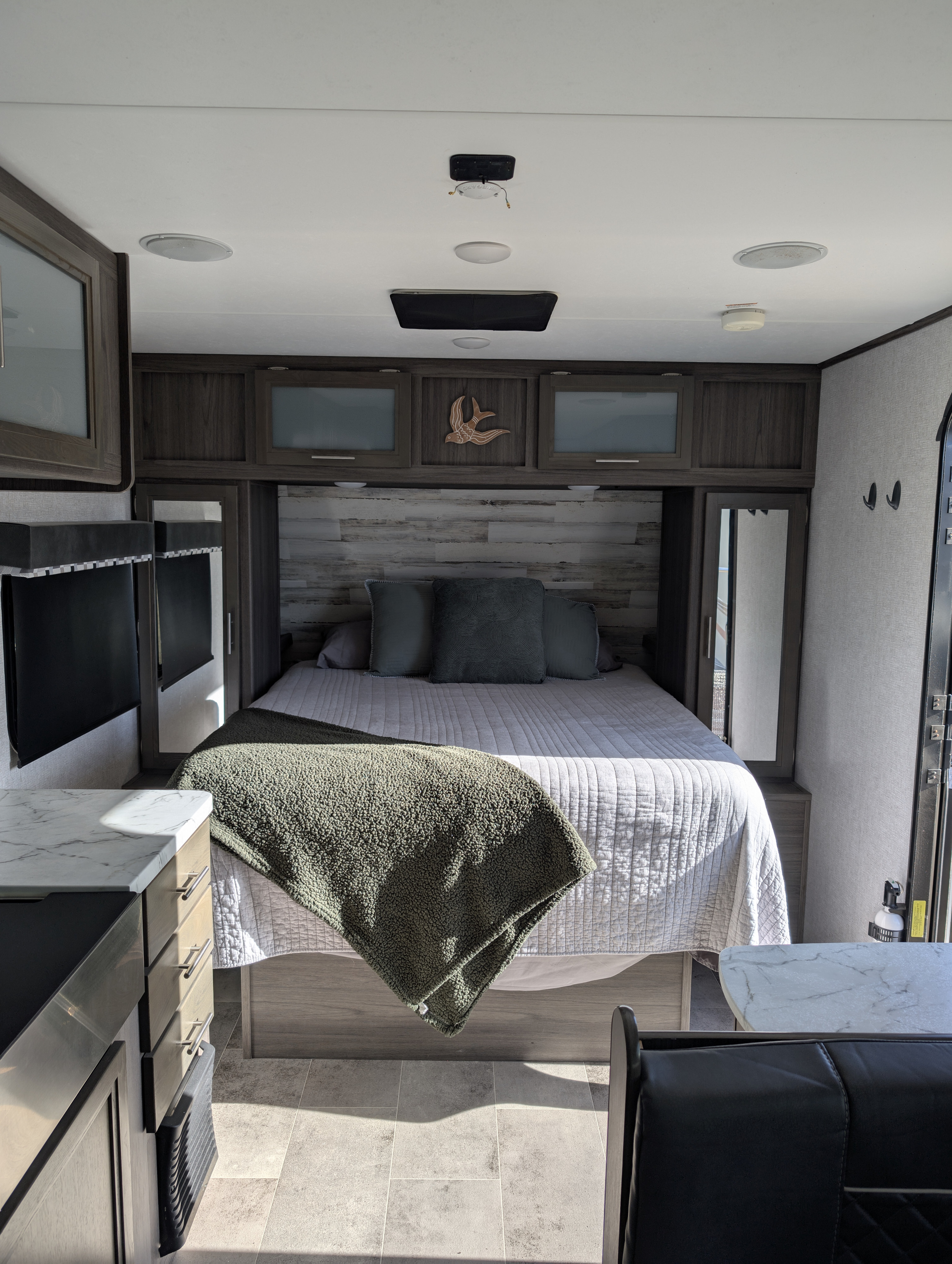 Spacious RV rental bedroom with a comfy bed, modern cabinets, and bright living space. Ideal for your next adventure!. Dutchmen Kodiak ultralight 2021