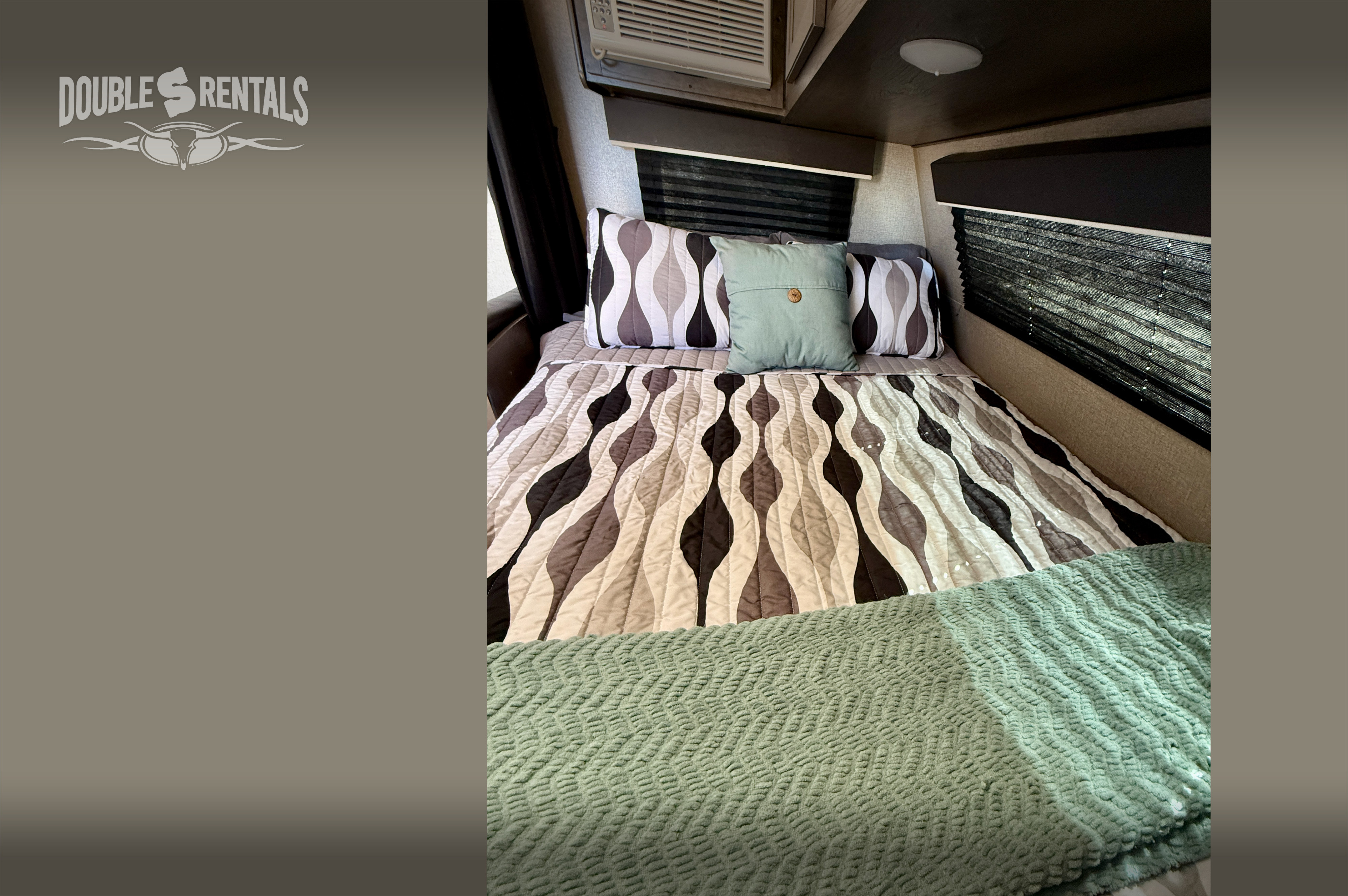 This clean RV rental bedroom features patterned bedding, a green accent pillow, window blinds, and AC.. Jayco Jay Flight 174BH 2020