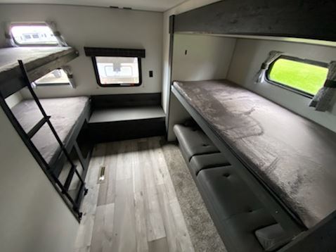 Explore this RV rental's interior: multi-level bunk beds, cozy seating, and windows for your next adventure.. K-Z Manufacturing Sportsmen 332BHKSE 2022