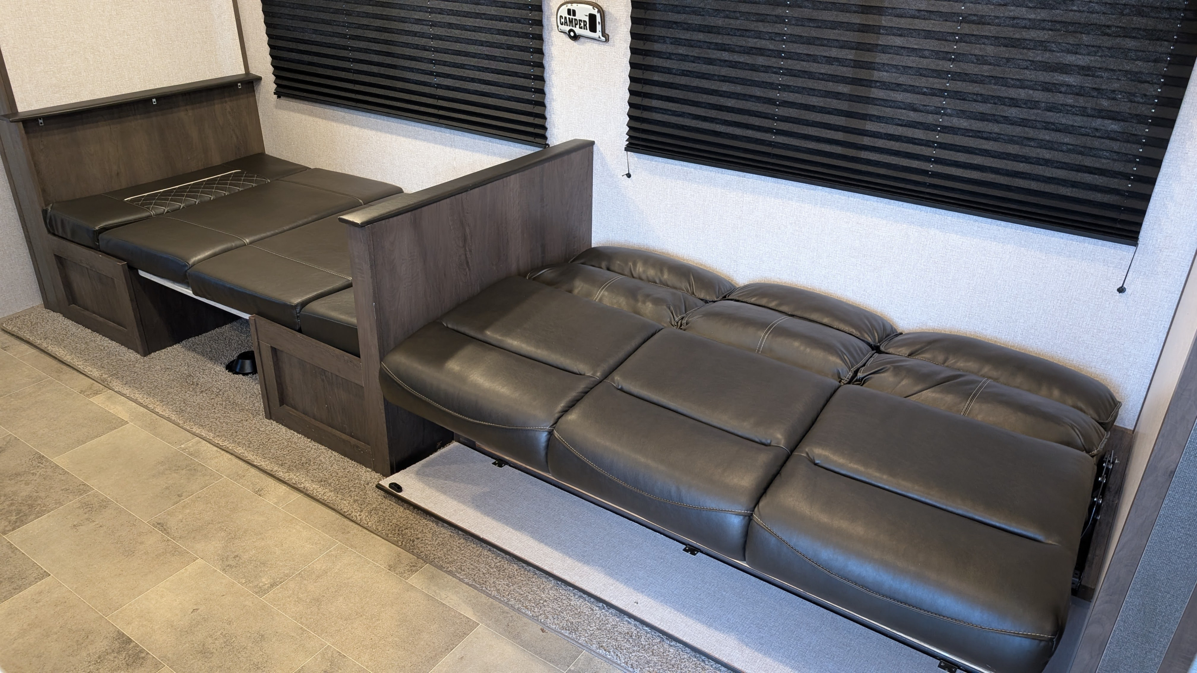Spacious RV rental interior featuring versatile convertible dinette seating and an extended sofa bed for comfort.. Dutchmen Coleman Lantern LT 2021