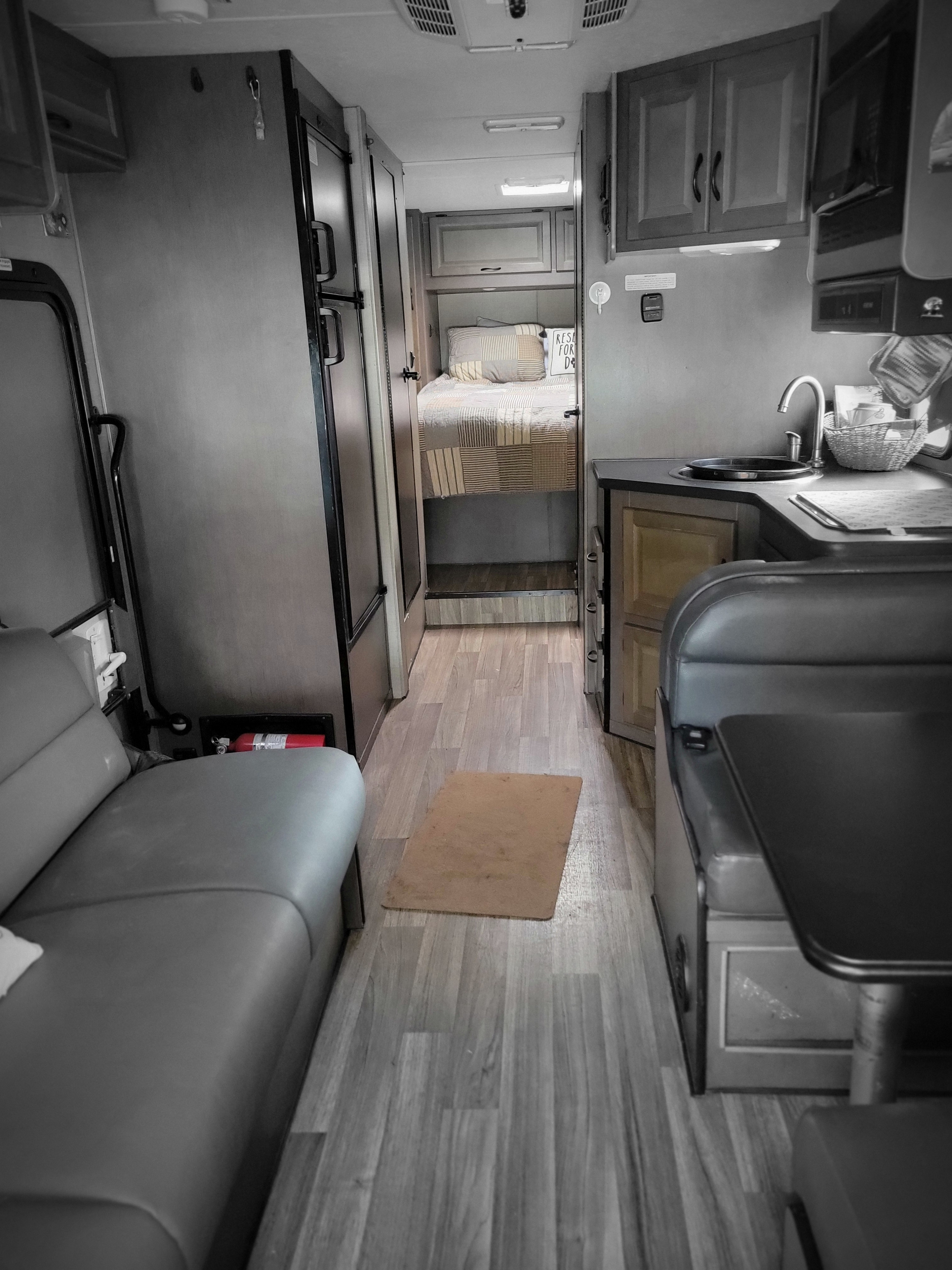 RV rental interior: A functional mobile living space with a compact kitchen, dinette, and a cozy bedroom in the back.. Thor Majestic 2019
