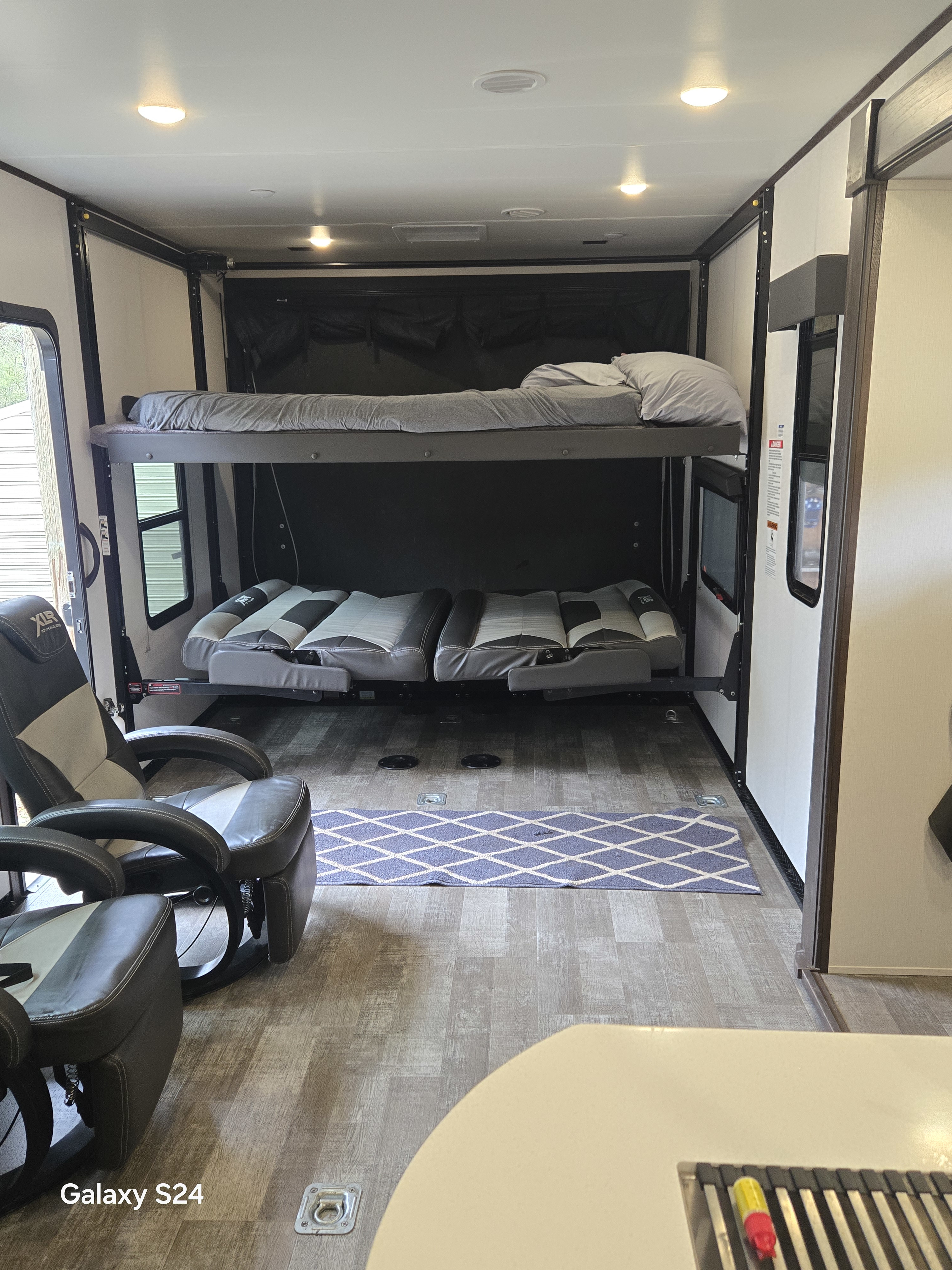 Explore this versatile RV rental: a toy hauler with adjustable bunk beds, comfy recliners, and open floor space.. Forest River XLR Hyperlite Toy Hauler 2023