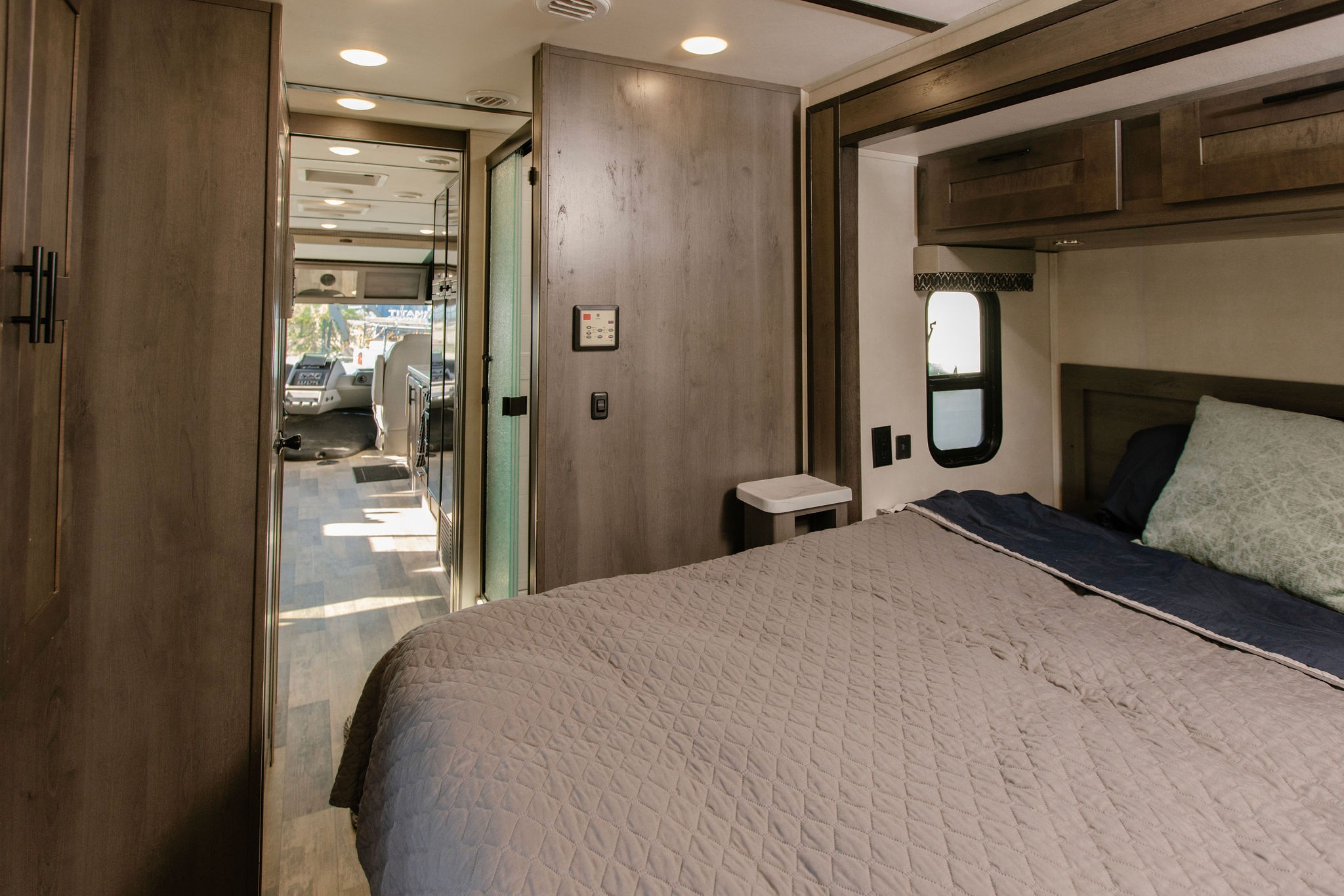 Spacious RV rental interior: cozy bedroom with modern design, looking into the living area & cockpit. Perfect for travel.. Forest River Fr3 2022