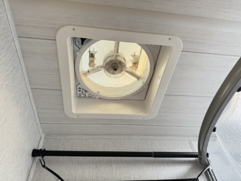 RV rental: Bright ceiling with a roof vent fan & a black closet rod. Ideal for fresh air & hanging clothes.. Forest River Wildwood Platinum 2024