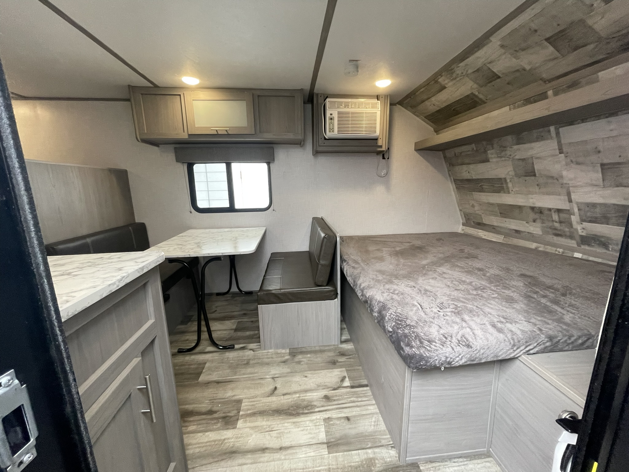 Inside this RV rental: comfortable bed, dinette, AC unit, and storage cabinets. Ready for your adventure.. Dutchmen Coleman Lantern 2022