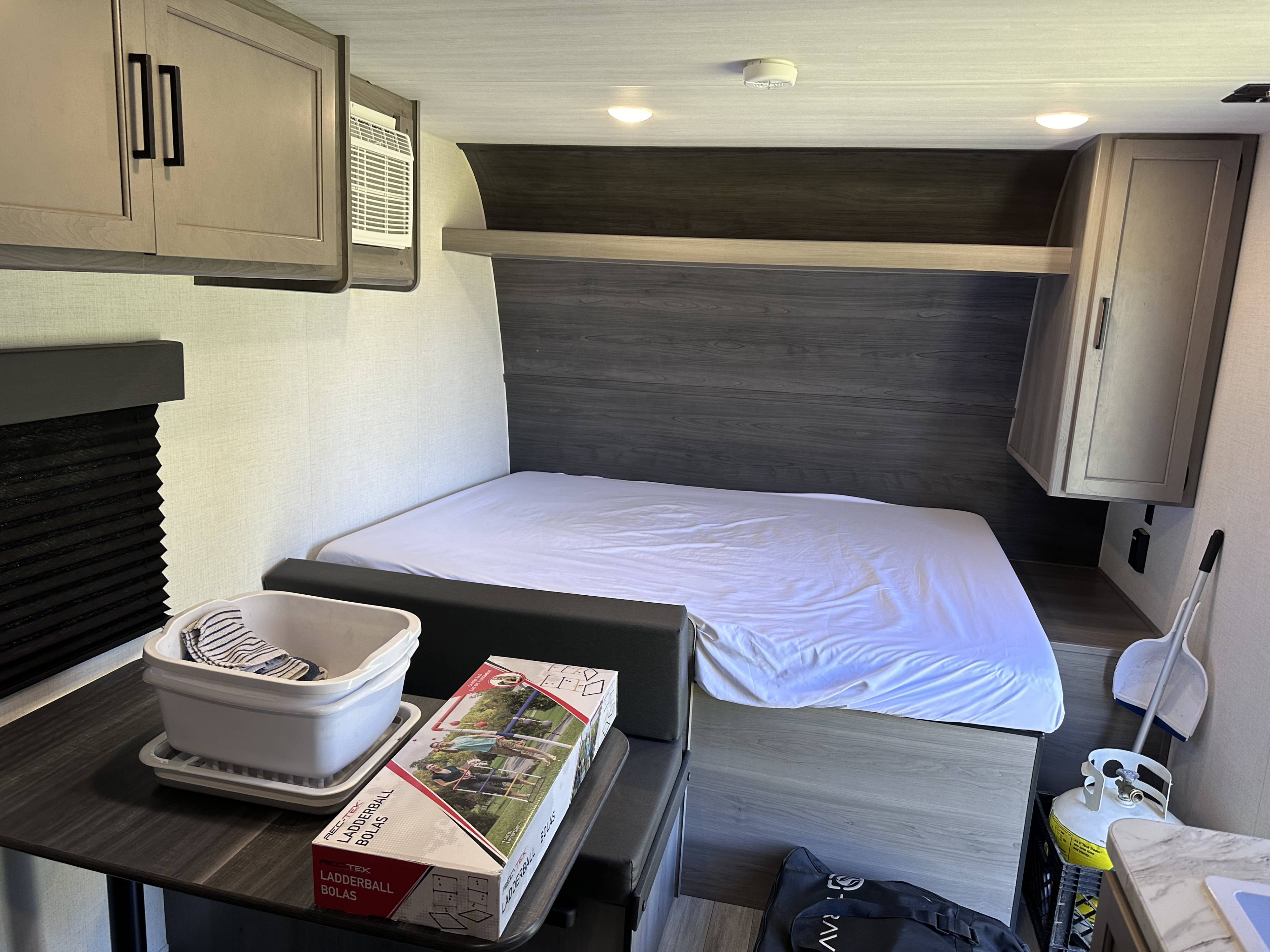 Cozy RV rental interior featuring a bedroom with bed, dinette, kitchen area, and storage for a fun trip.. Keystone RV Hideout 2024
