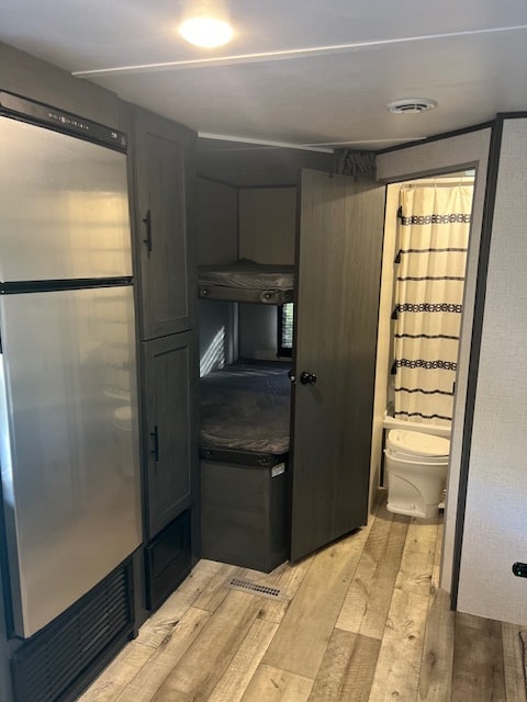 Inside this cozy RV rental: bunk beds, a refrigerator, and a bathroom with shower. Ideal for your next family adventure.. Dutchmen Colorado 26BHC 2022
