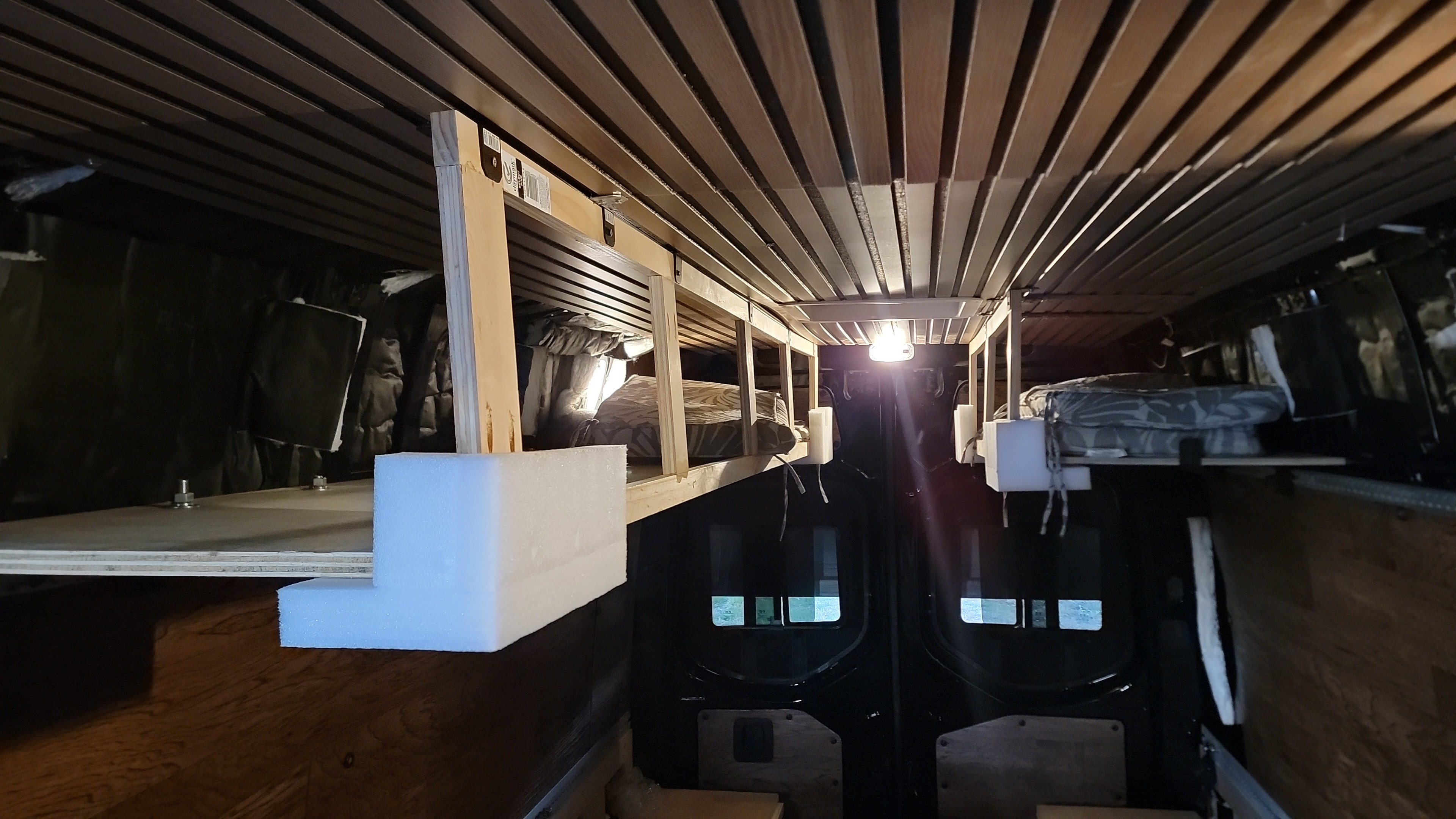 Experience a unique RV rental: a spacious van conversion with a sleek wood-slatted ceiling and multi-level bunk beds.. Mercedes-Benz Sprinter 2021