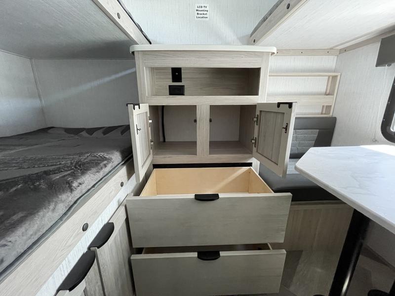 RV rental interior: light wood storage cabinets with open drawers, a bed, and dinette area are visible.. Cruiser Rv Corp Shadow Cruiser 2022