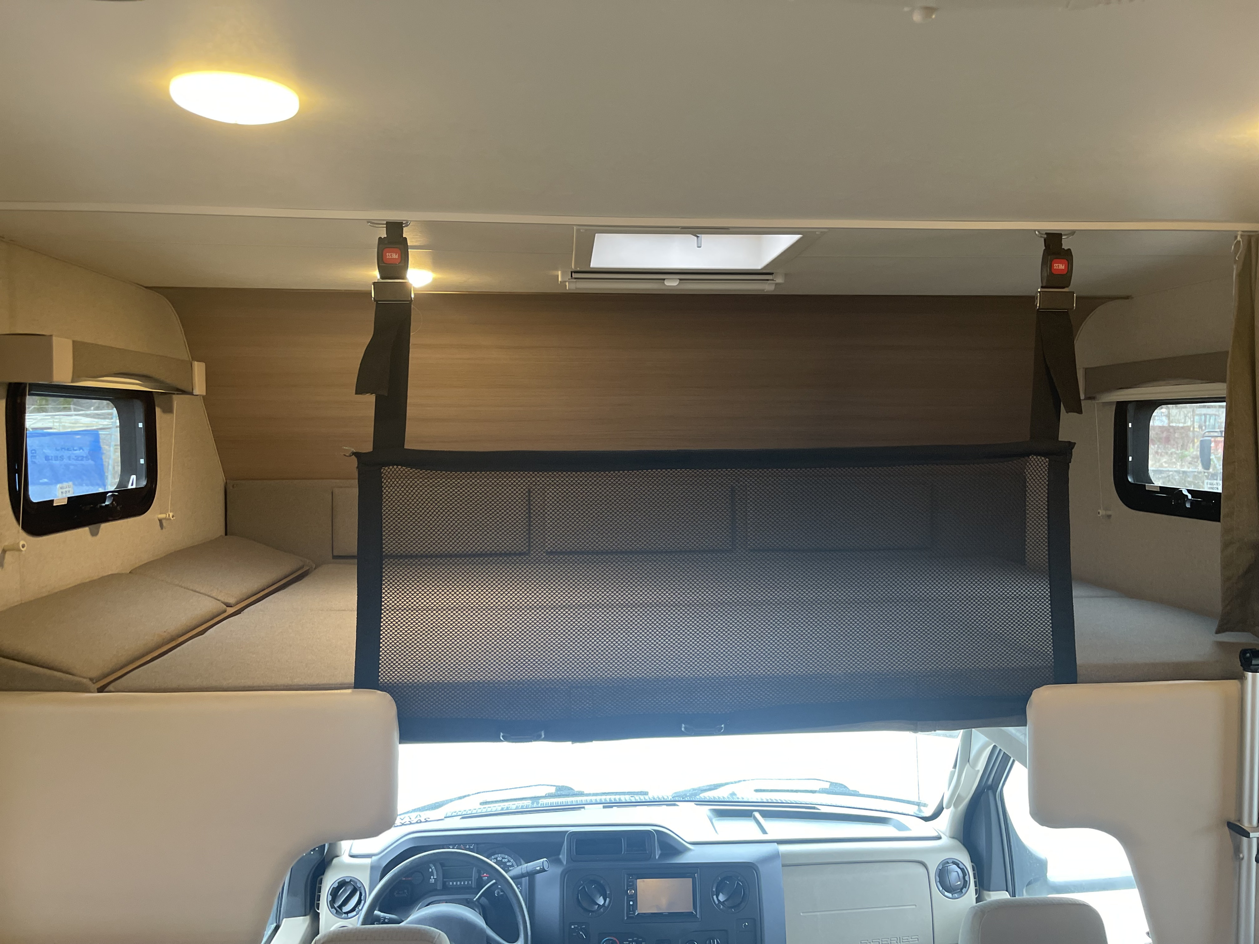 RV rental interior: cozy cab-over bunk bed with safety net, roof vent, & side windows.. Adventurer 24DS 2021