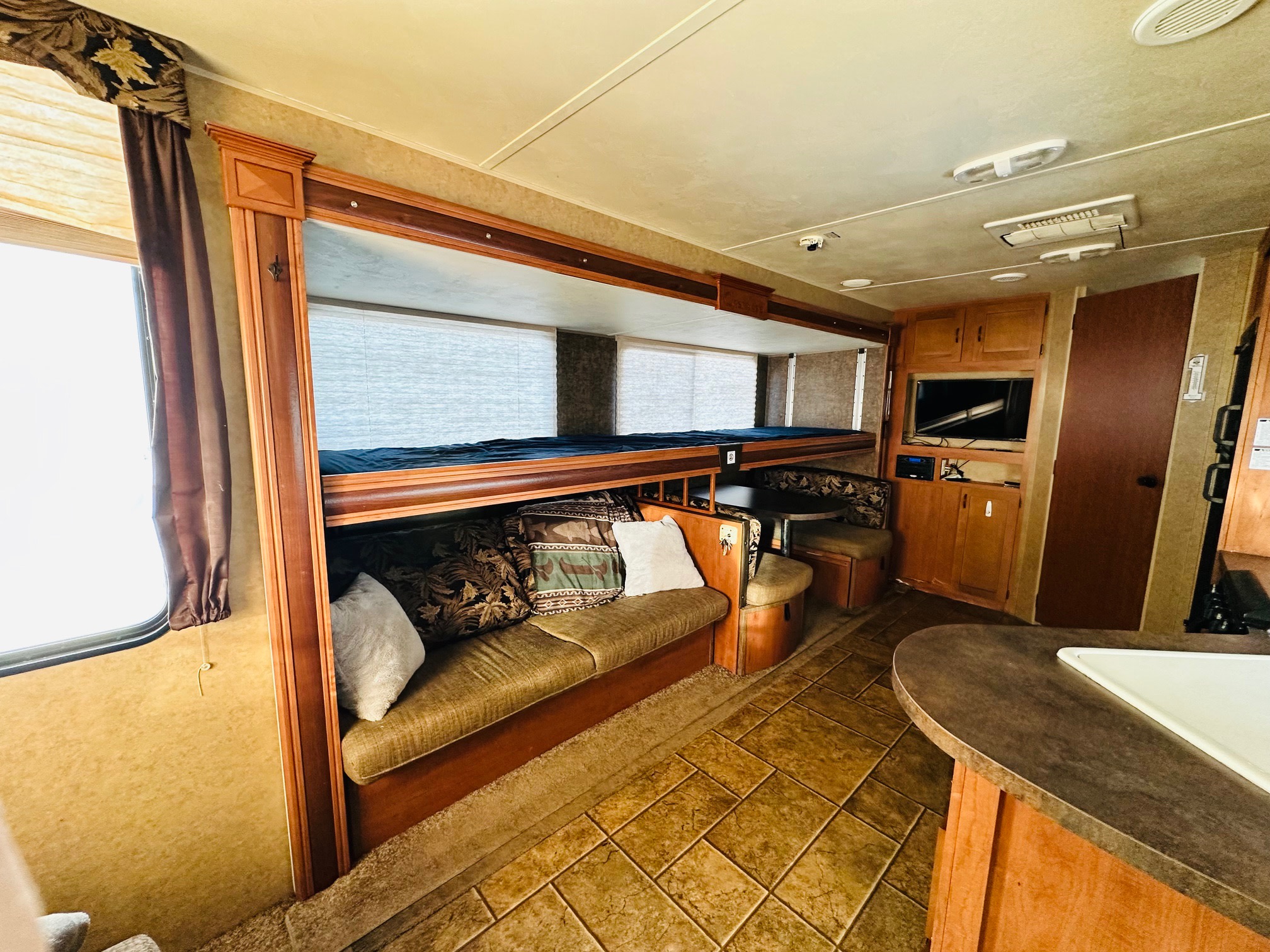 This RV rental's interior features bunk beds, a sofa, dinette, and kitchen counter for comfortable travel.. Forest River Cherokee Grey Wolf 2013