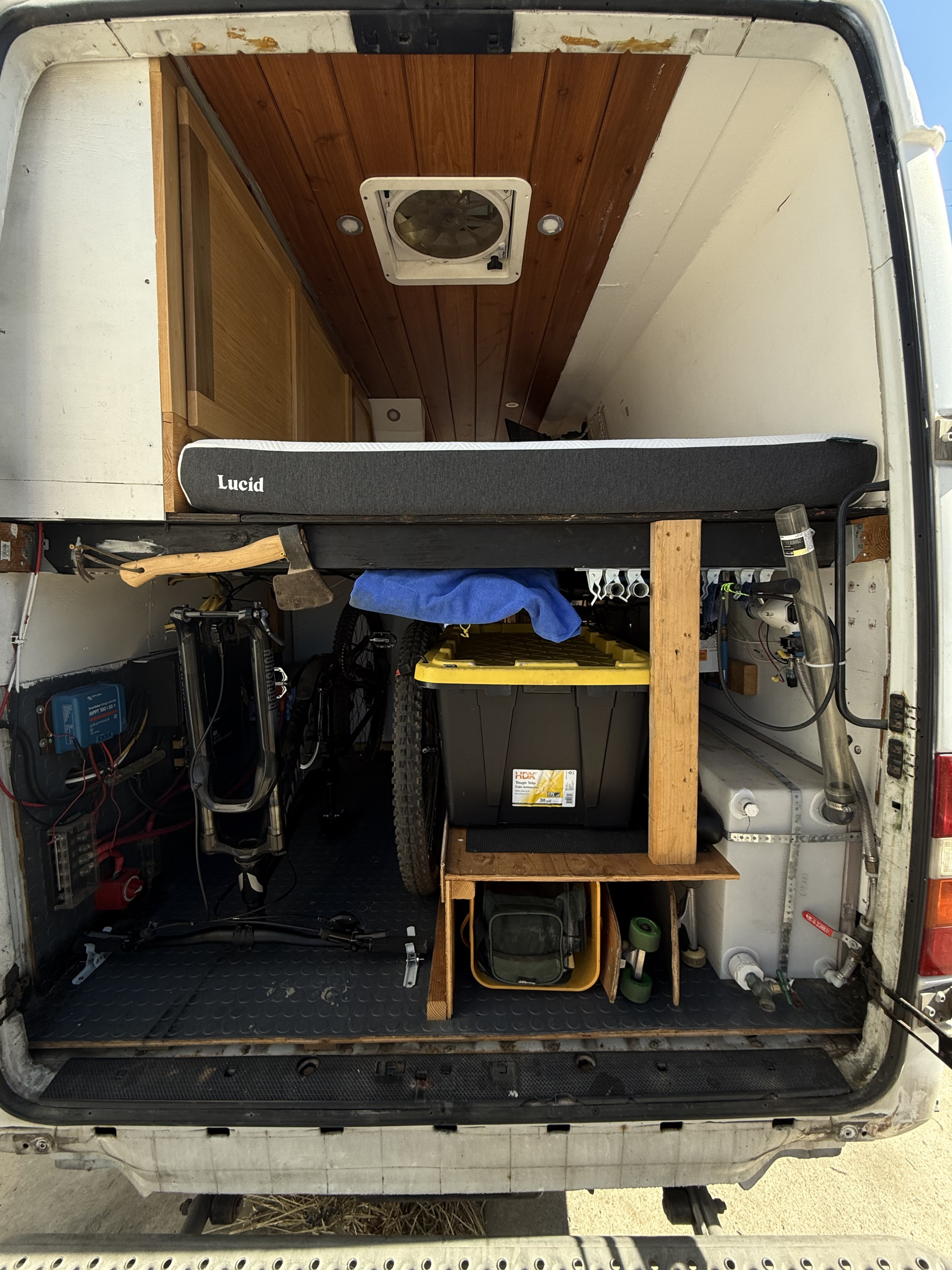Explore this RV rental's clever interior: a comfy bed, bike storage, Victron electrics, and fresh water tank for adventures.. Dodge Sprinter 2006