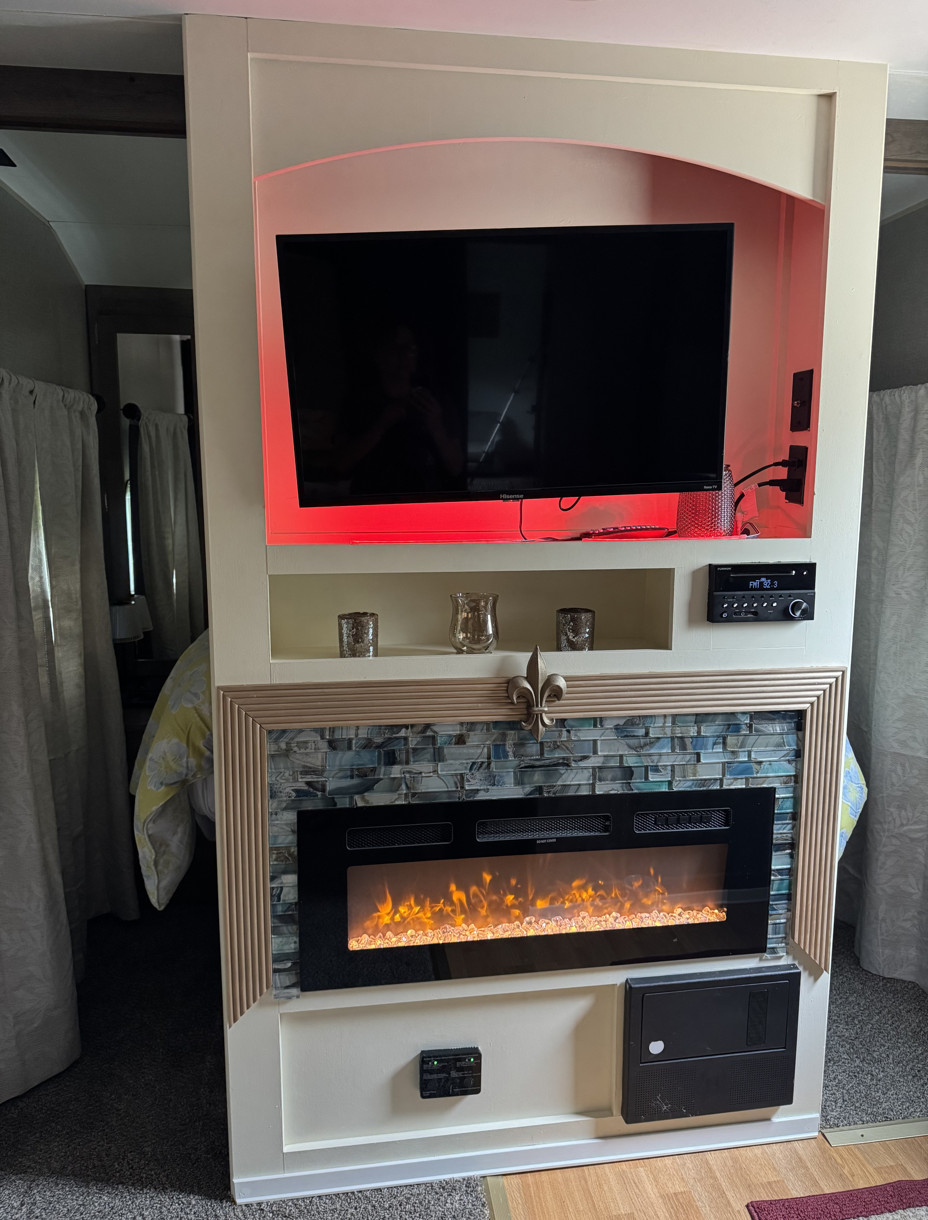 RV rental: Light entertainment center with a TV, electric fireplace (blue tile), stereo, and controls. Cozy bedroom divider.. Aspen Trail Aspen Trail Trailer 2019