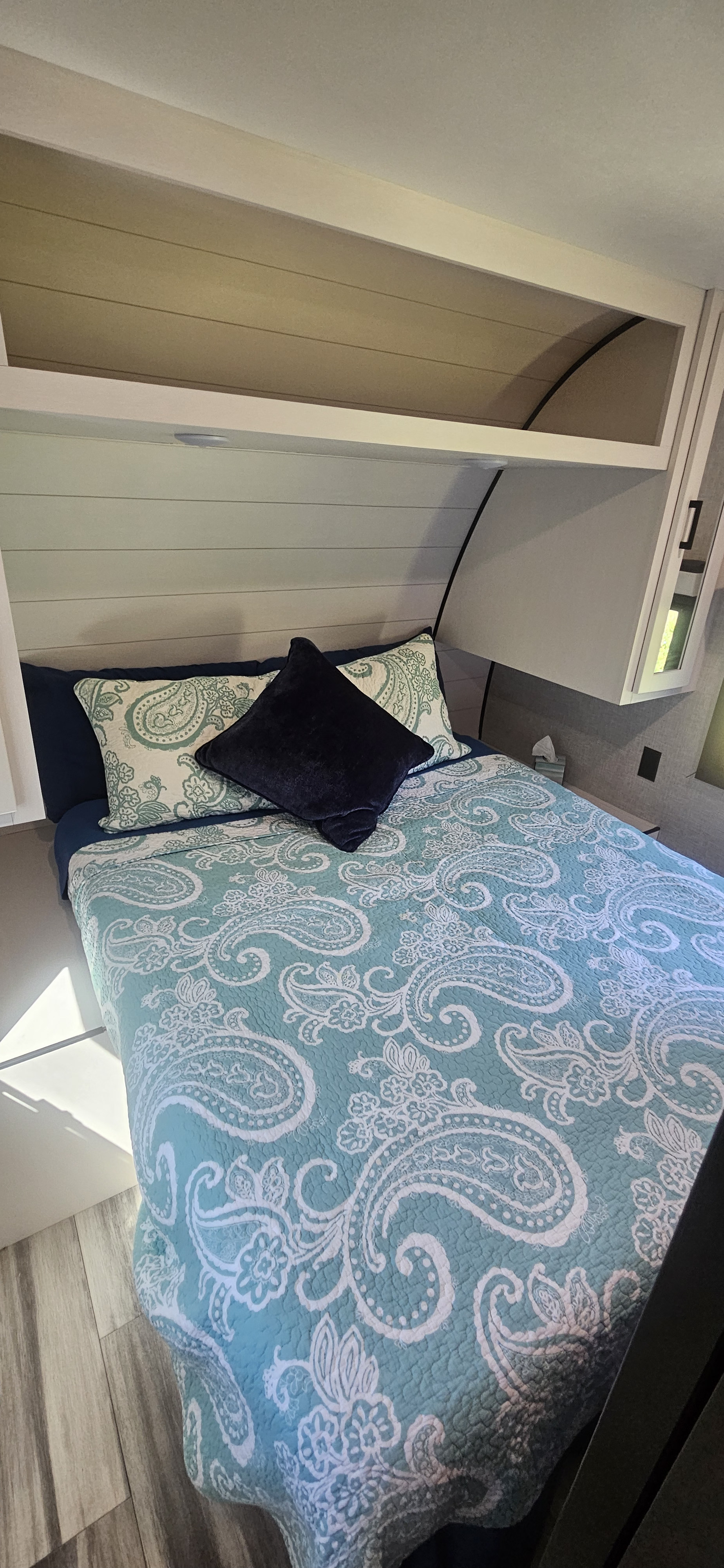 Inviting bedroom in an RV rental with a comfortable bed, stylish paisley bedding, and convenient overhead storage.. Jayco Jay Flight 267BHS 2024