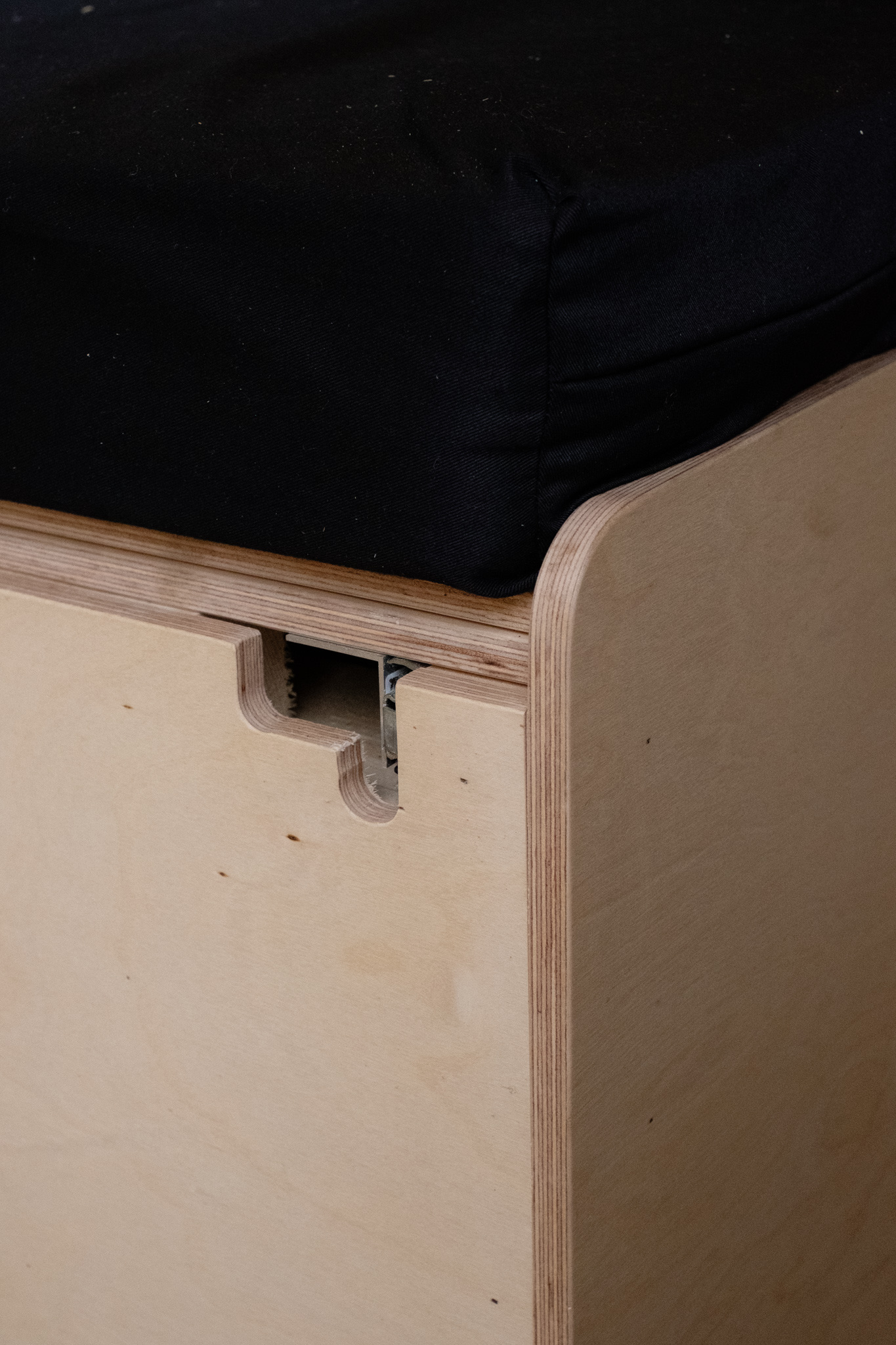 RV rental interior: custom plywood drawer with a cut-out handle under a black mattress.. Dodge Sprinter Van 2006