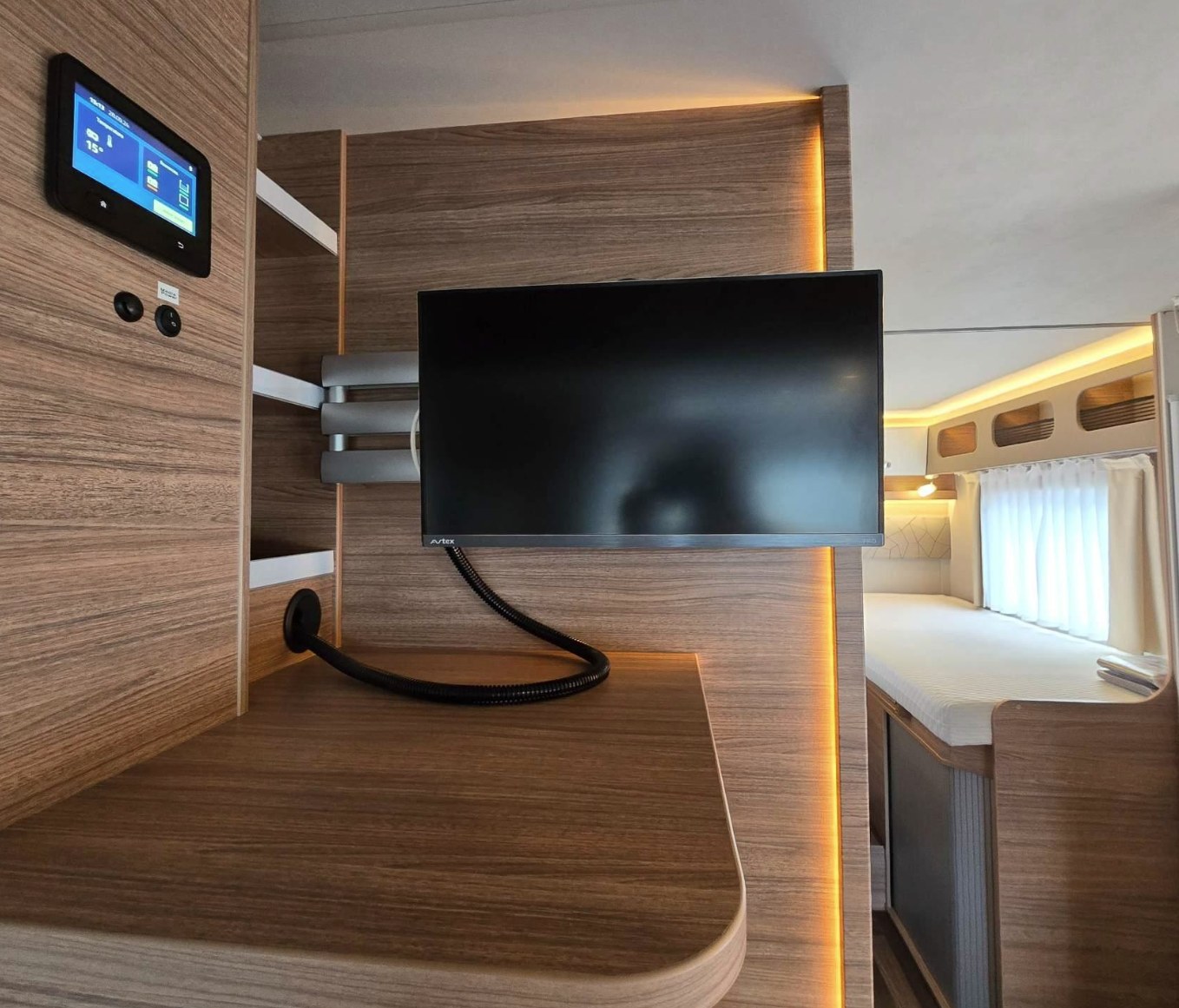 Modern RV rental interior with a digital control panel, adjustable TV, and comfortable bed for your journey.. Weinsberg CaraSuite 700 ME 2025