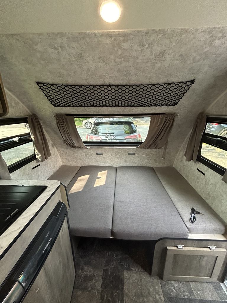 This rv rental offers a versatile interior with a convertible bed/seating area, compact kitchen, and overhead storage.. Prolite Prolite Trailer 2022