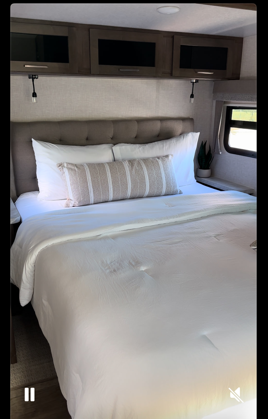 Cozy RV rental bedroom featuring a comfy bed with crisp white linens, a tufted headboard, and practical overhead storage.. Forest River Flagstaff Super Lite 2023