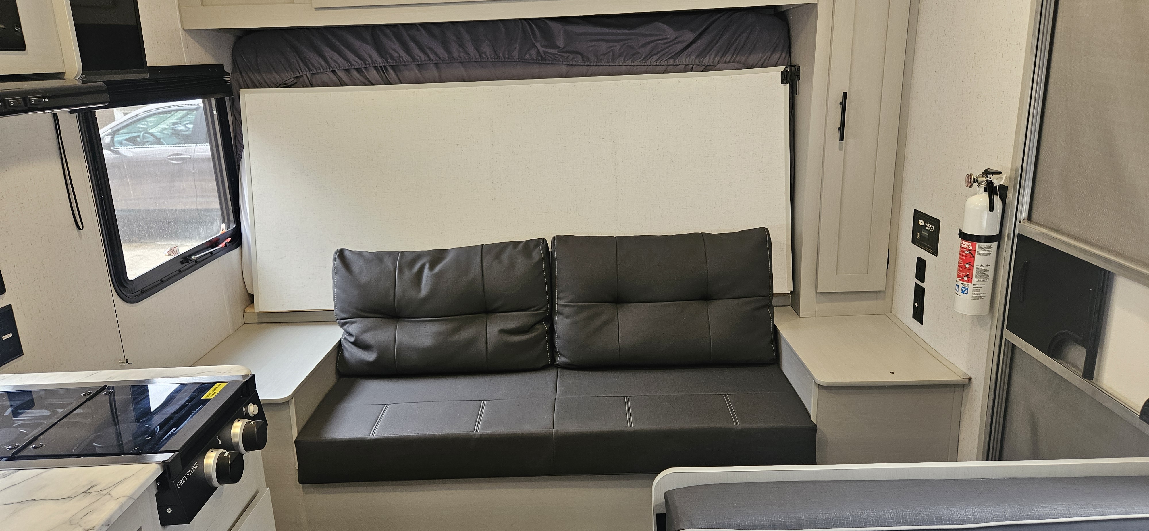 Step inside this modern RV rental! View the multi-functional living space with a comfy sofa, fold-down bed, and compact kitchen.. Forest River Salem FSX Plantium 2022