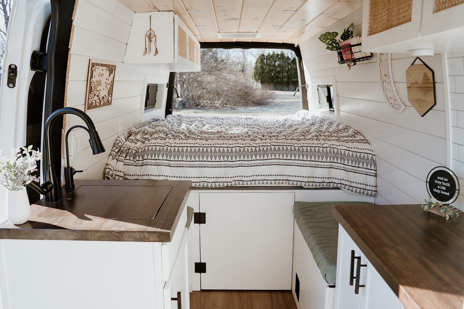 Step into this bright RV rental! Features a comfy bed, dark wood kitchenette, and bench seating. Perfect for your next adventure.. Mercedes Sprinter 2021