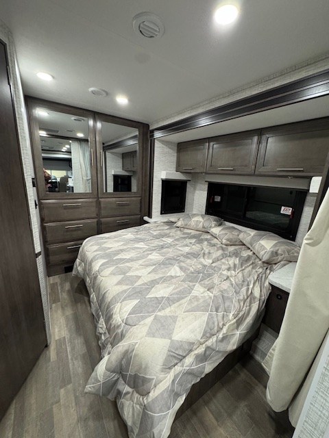 Inside this RV rental is a well-appointed bedroom with a cozy bed, ample storage, and modern design for comfortable travel.. Jayco Alante 2025