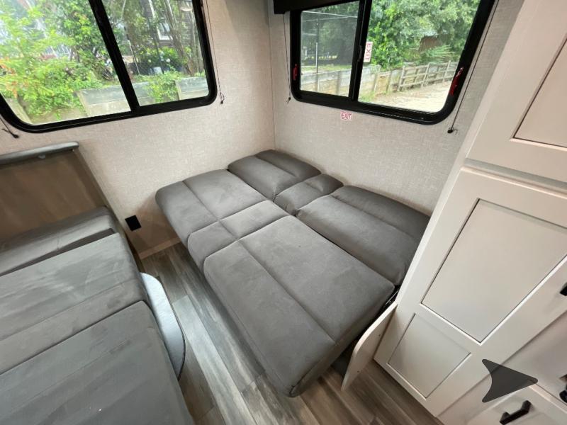 Modern RV rental interior with gray convertible beds/seating, large windows, and white storage. Perfect for road trips and camping.. Jayco Jay Flight SLX 210QB 2025