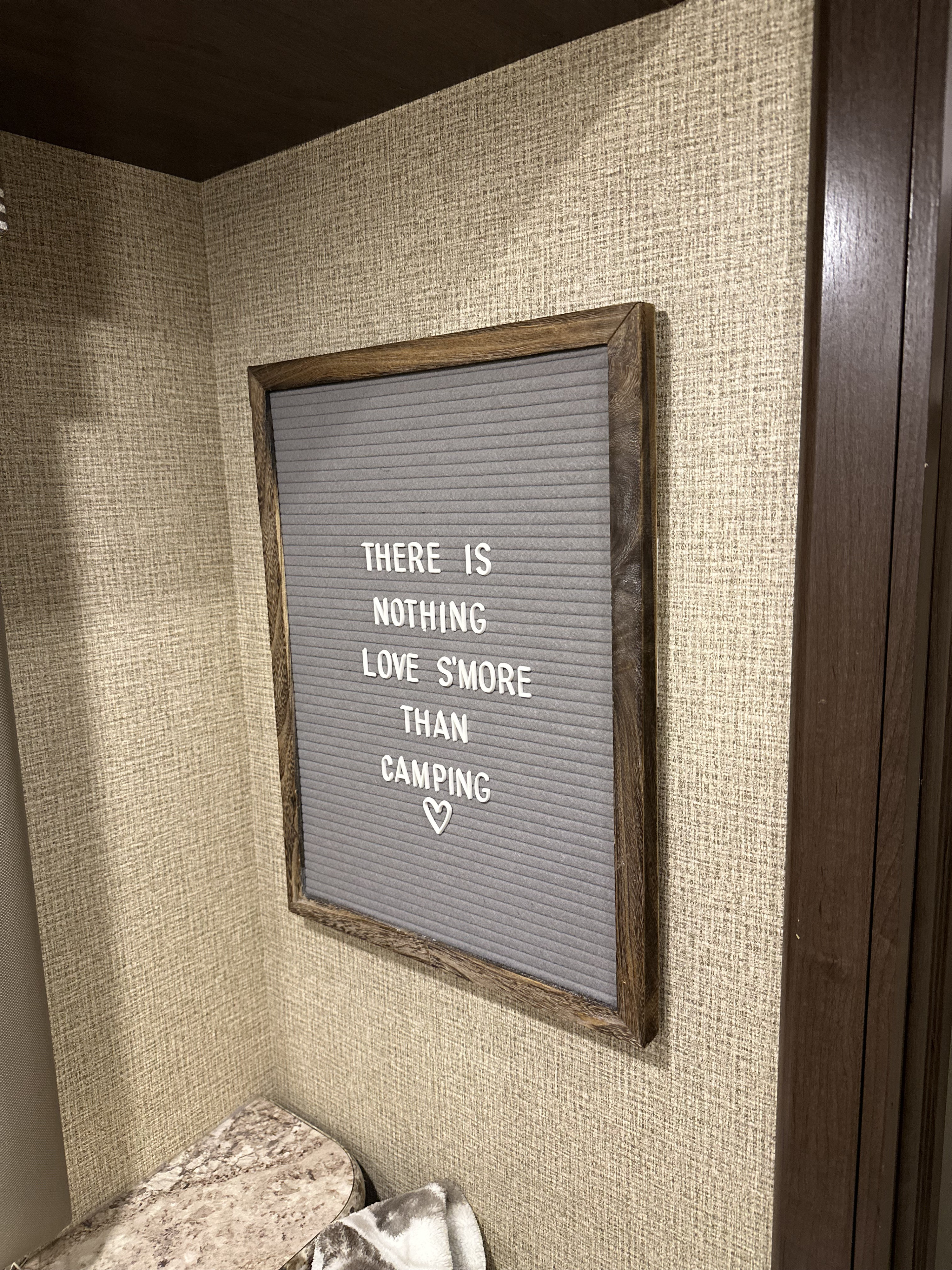 Cozy RV rental interior with a fun "Love S'more Than Camping" letter board, perfect for your next adventure.. Thor Four Winds 2018