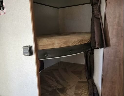 RV rental bunk beds: Two cozy bunks with mattresses & dark privacy curtains, plus a wall-mounted thermostat.. Jayco Jay Flight 2019