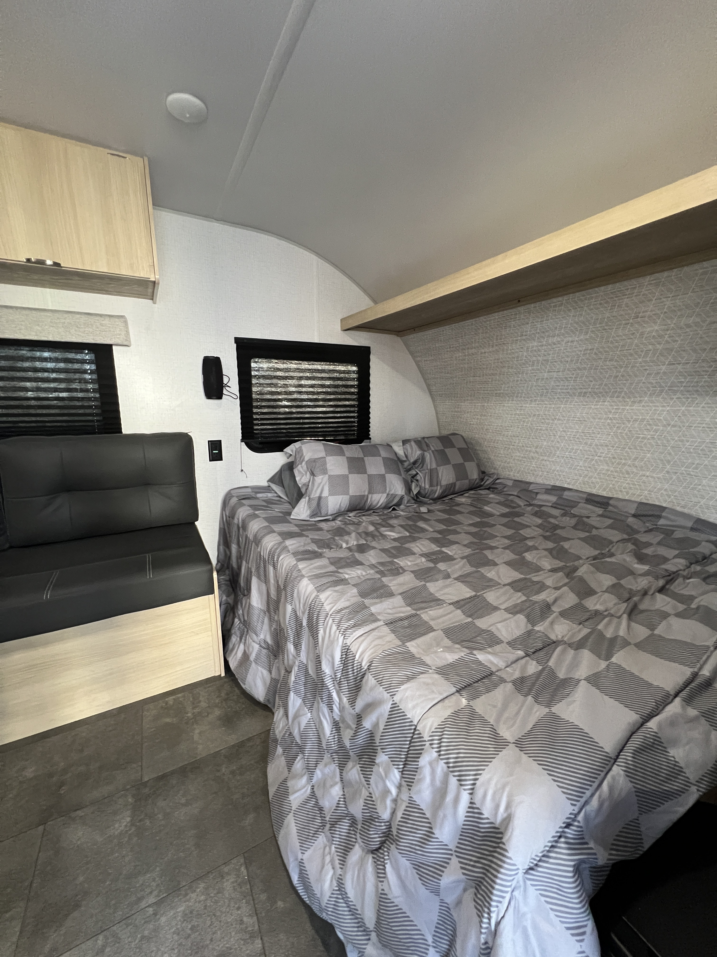 Cozy RV rental interior featuring a bed, sofa, and light wood finishes, ideal for comfortable travels.. Forest River Salem FSX 2024