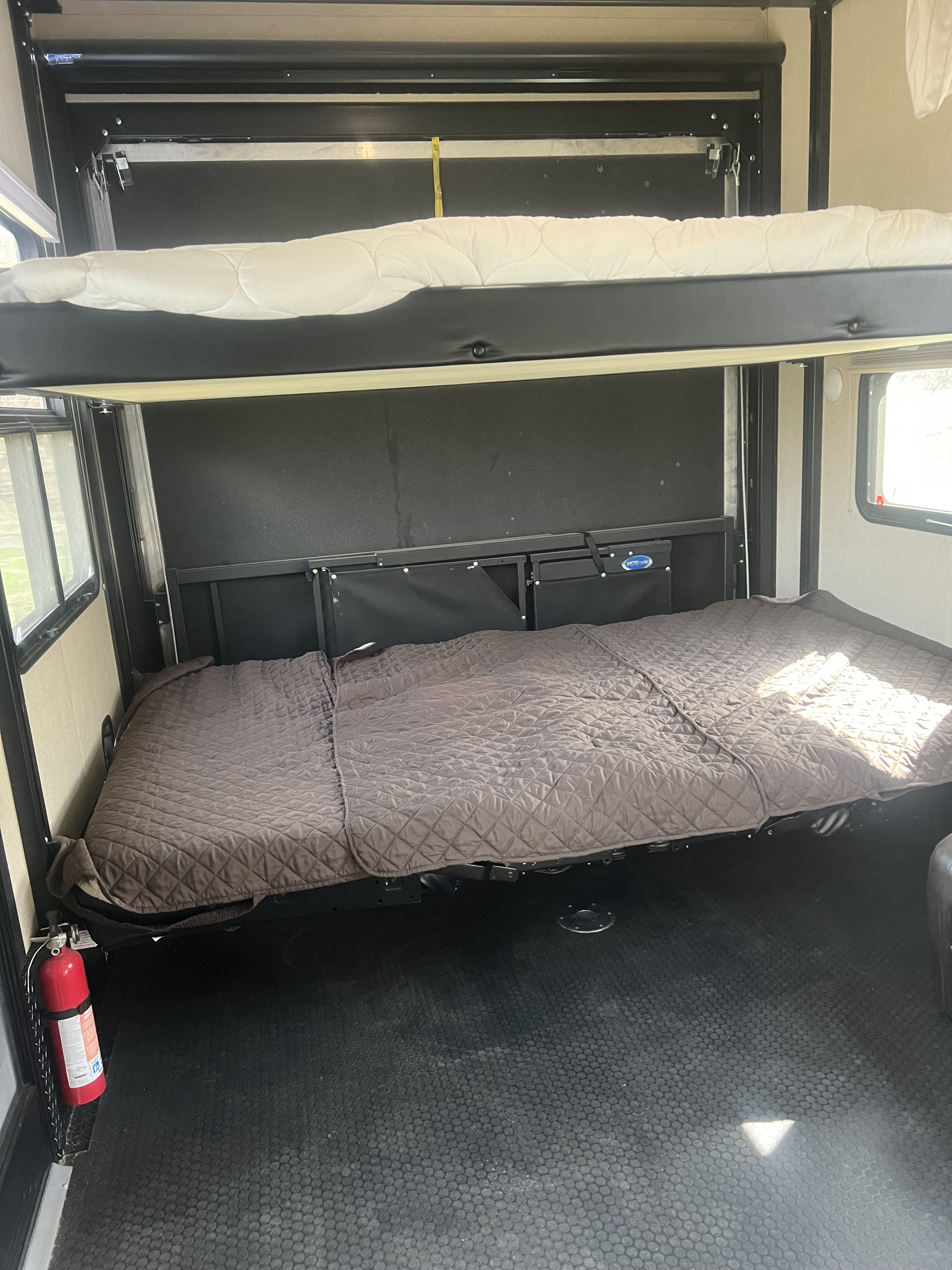 RV rental interior: dual bunk beds offer ample sleeping space. Features include a textured floor & safety fire extinguisher.. Dutchmen Voltage 3305 2018