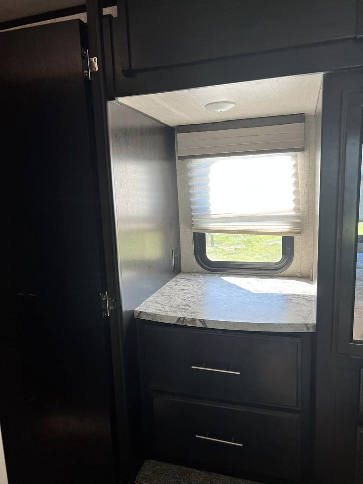 RV rental: Compact interior with a window, pleated blind, countertop, and two built-in storage drawers.. Heart Land Road Warrior 2017