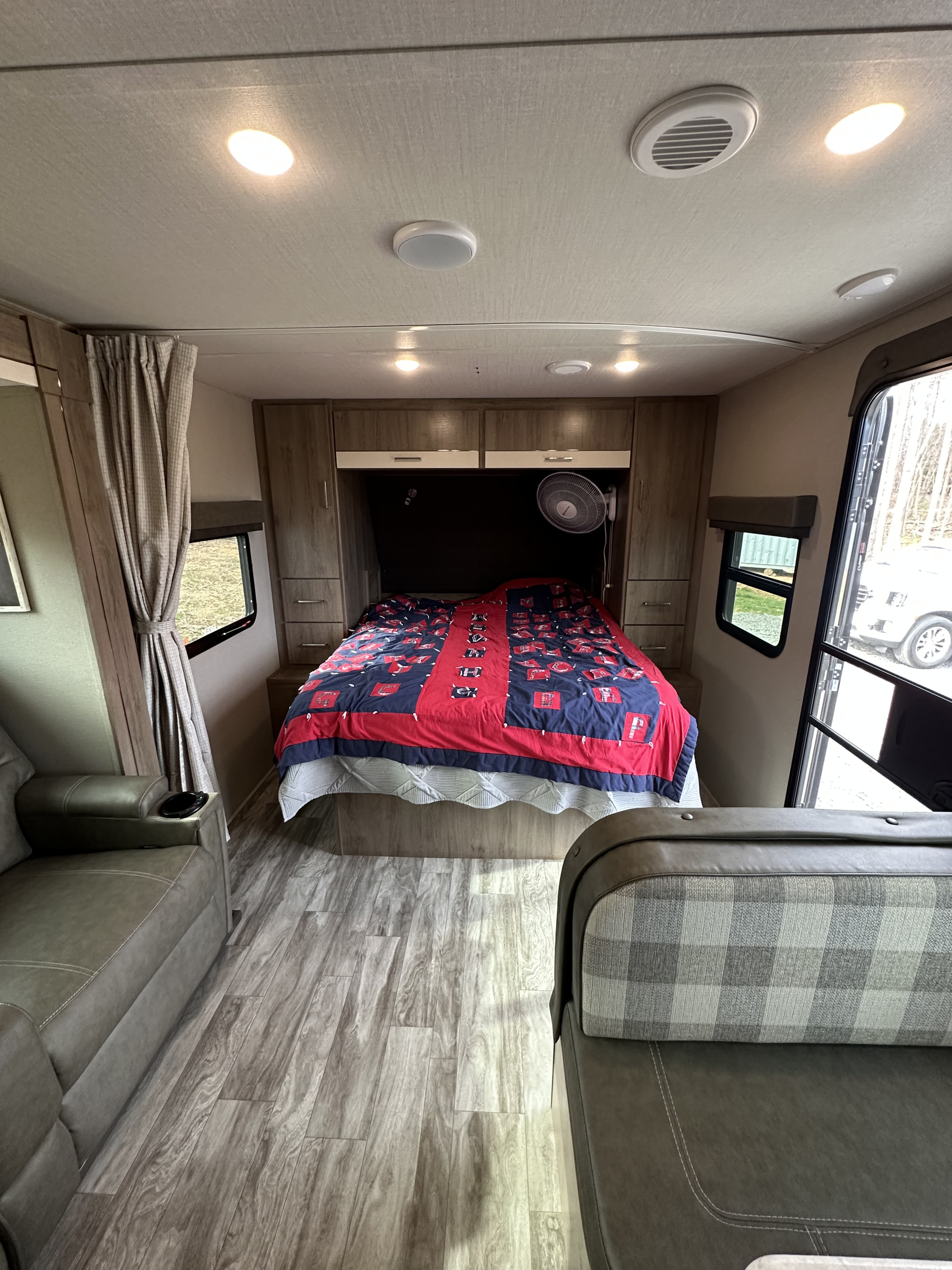 This RV rental offers a spacious interior with a cozy bedroom, ample storage, comfortable recliner, and dinette seating.. Grand Design Imagine XLS 2022