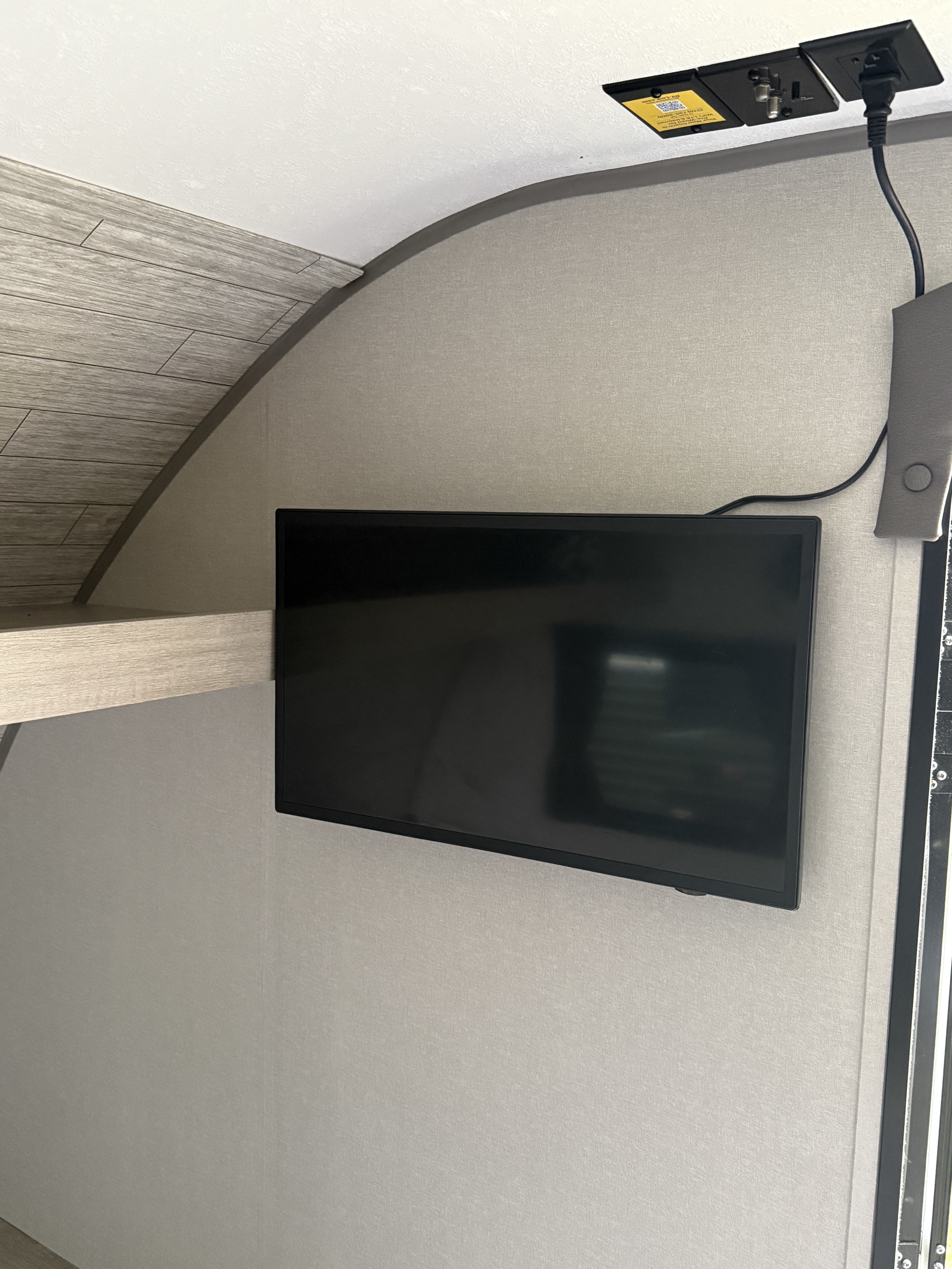 RV rental interior featuring a mounted TV with power and connectivity options, including RV WiFi & LTE, for on-the-go entertainment.. Forest River Coachmen Catalina Summit 2024