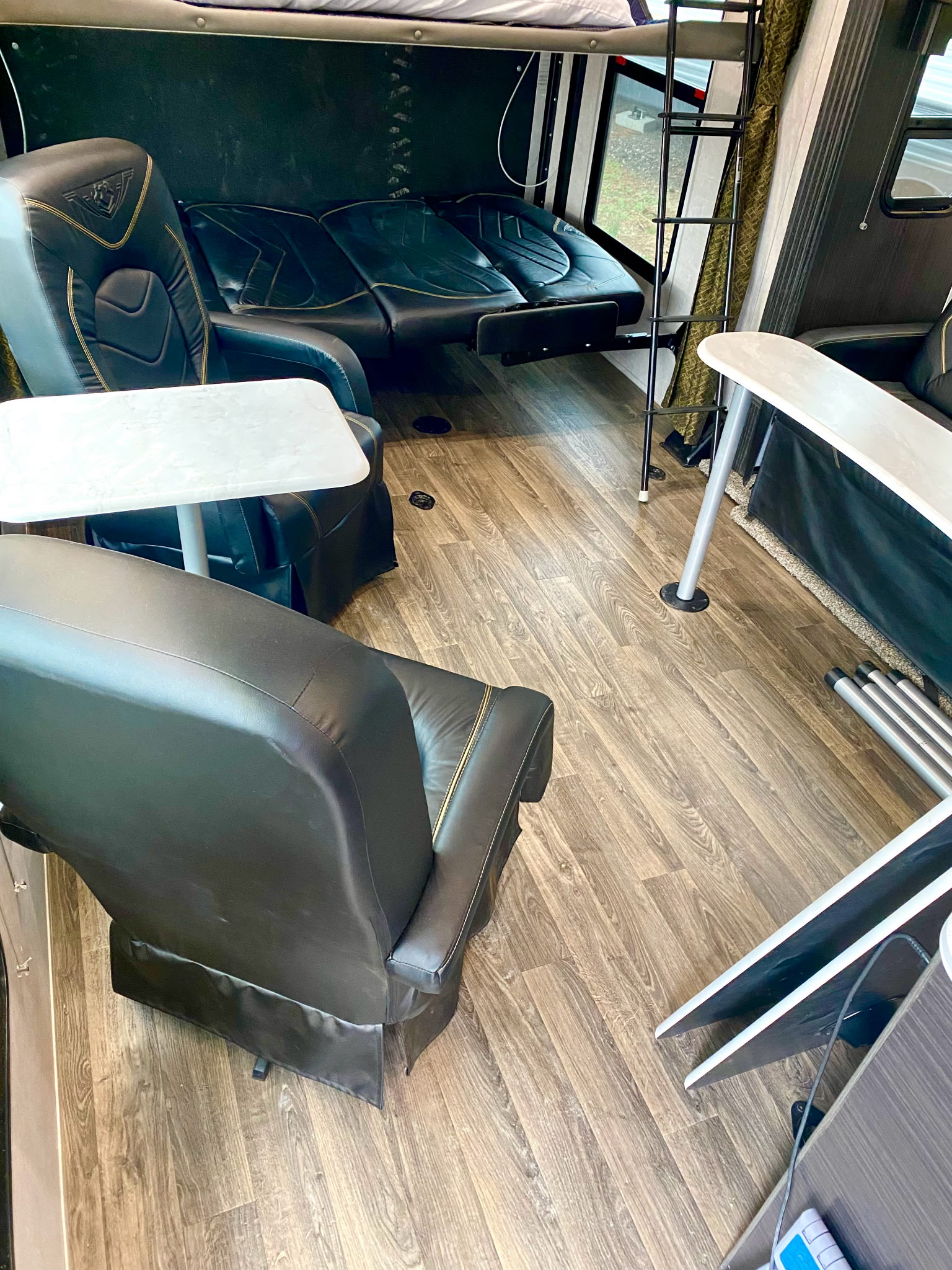 RV rental interior features black reclining chairs, bench, bunk bed, tables, and wood flooring.. Eclipse Recreational Vehicles Attitude 2023