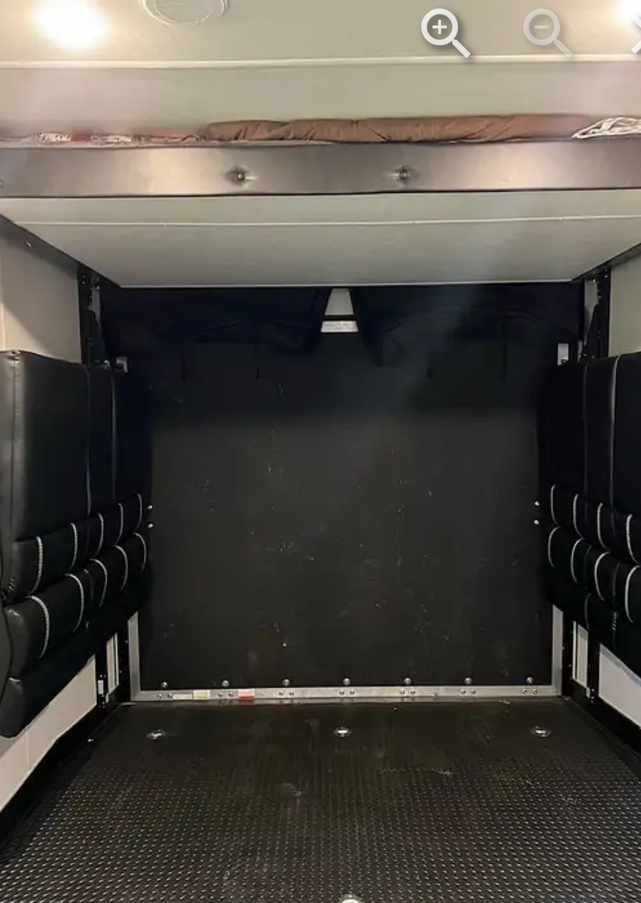 RV rental: Interior toy hauler garage with upper bunk bed, fold-down padded seating, and durable floor.. Forest River Cherokee Wolf Pack 2022