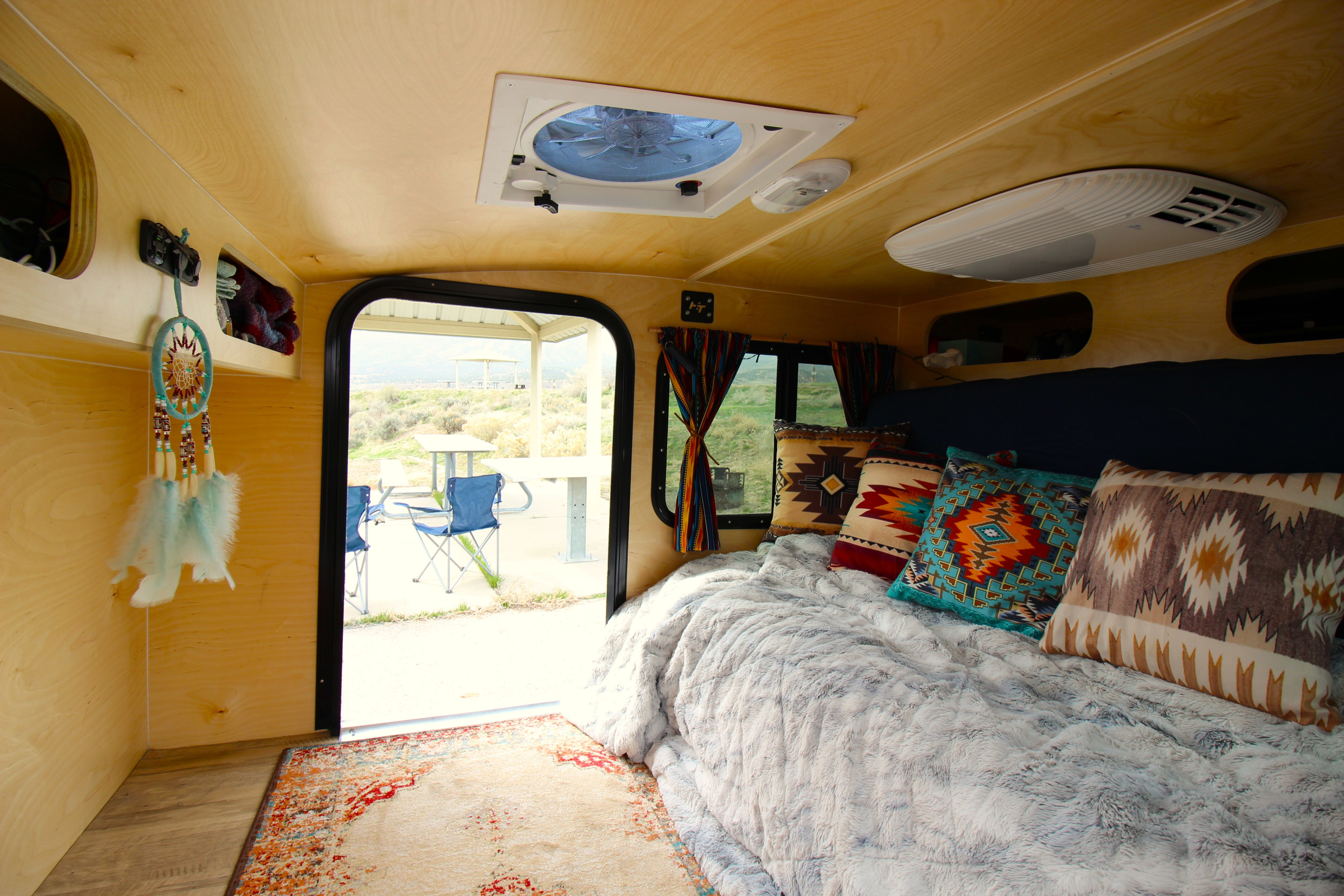 Step inside this cozy teardrop trailer, featuring a fluffy bed, Southwestern charm, and an inviting view of the outdoors. The couch folds into a soft double bed that is comfortable for people up to 6'3" in height. . Hiker Trailer 5x8 Mid-Range 2021