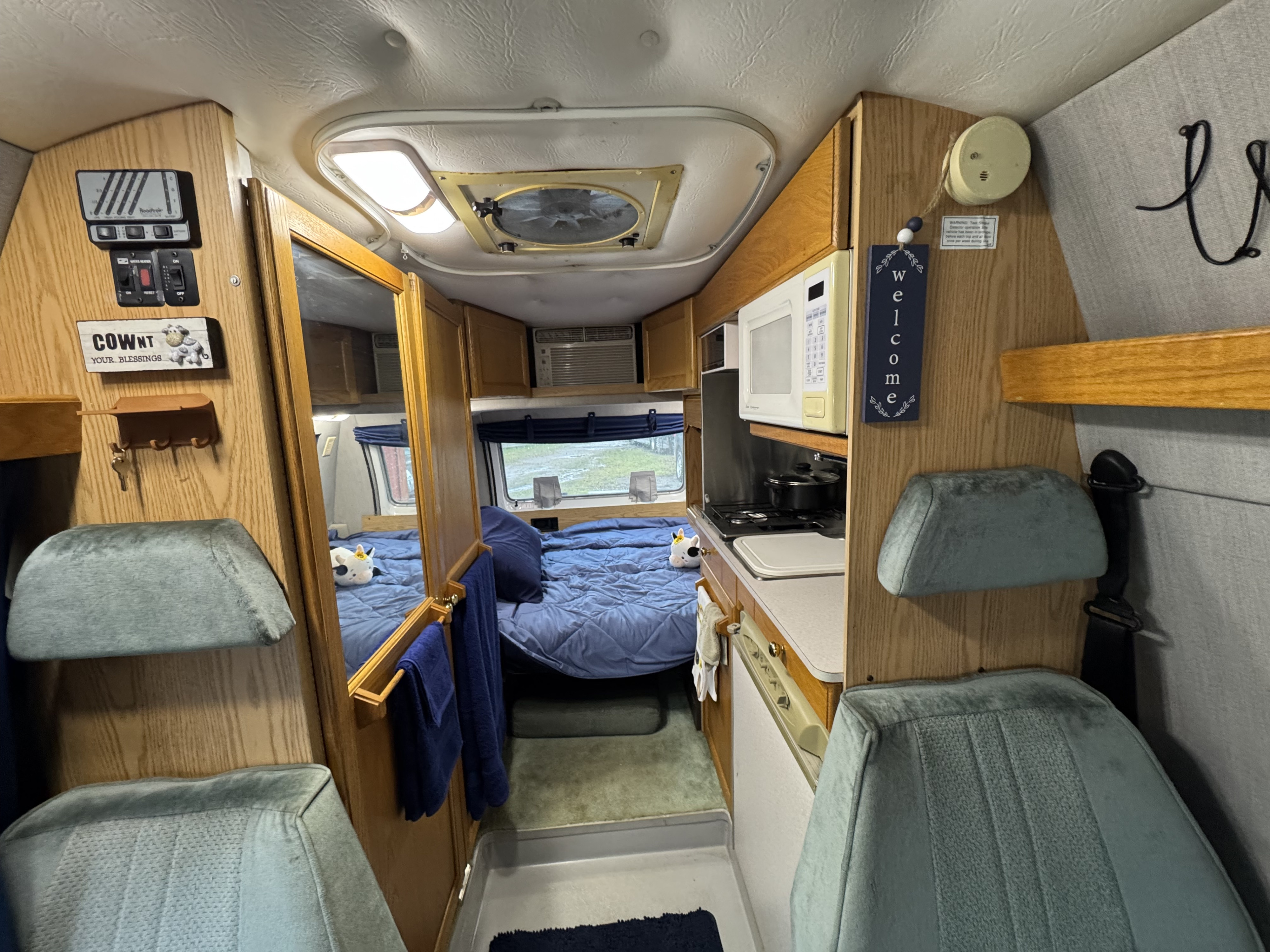 Front seating area with rear queen bed set up. Roadtrek 190 Versatile 2001