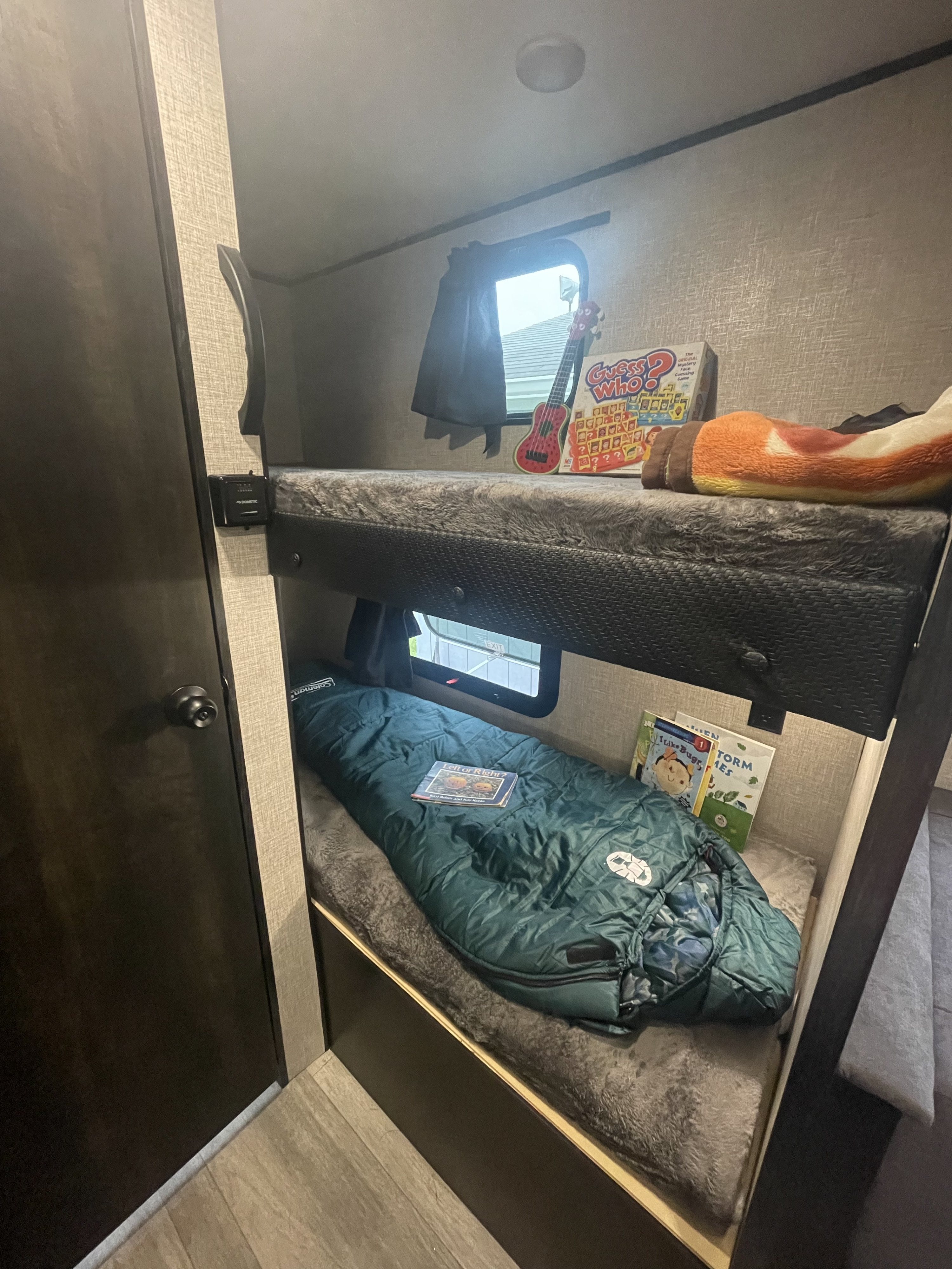 An RV rental's kid-friendly bunk beds: complete with games, books, a ukulele, and sleeping bags for adventure sleepovers.. Jayco Jay Flight SLX STX Edition 2022