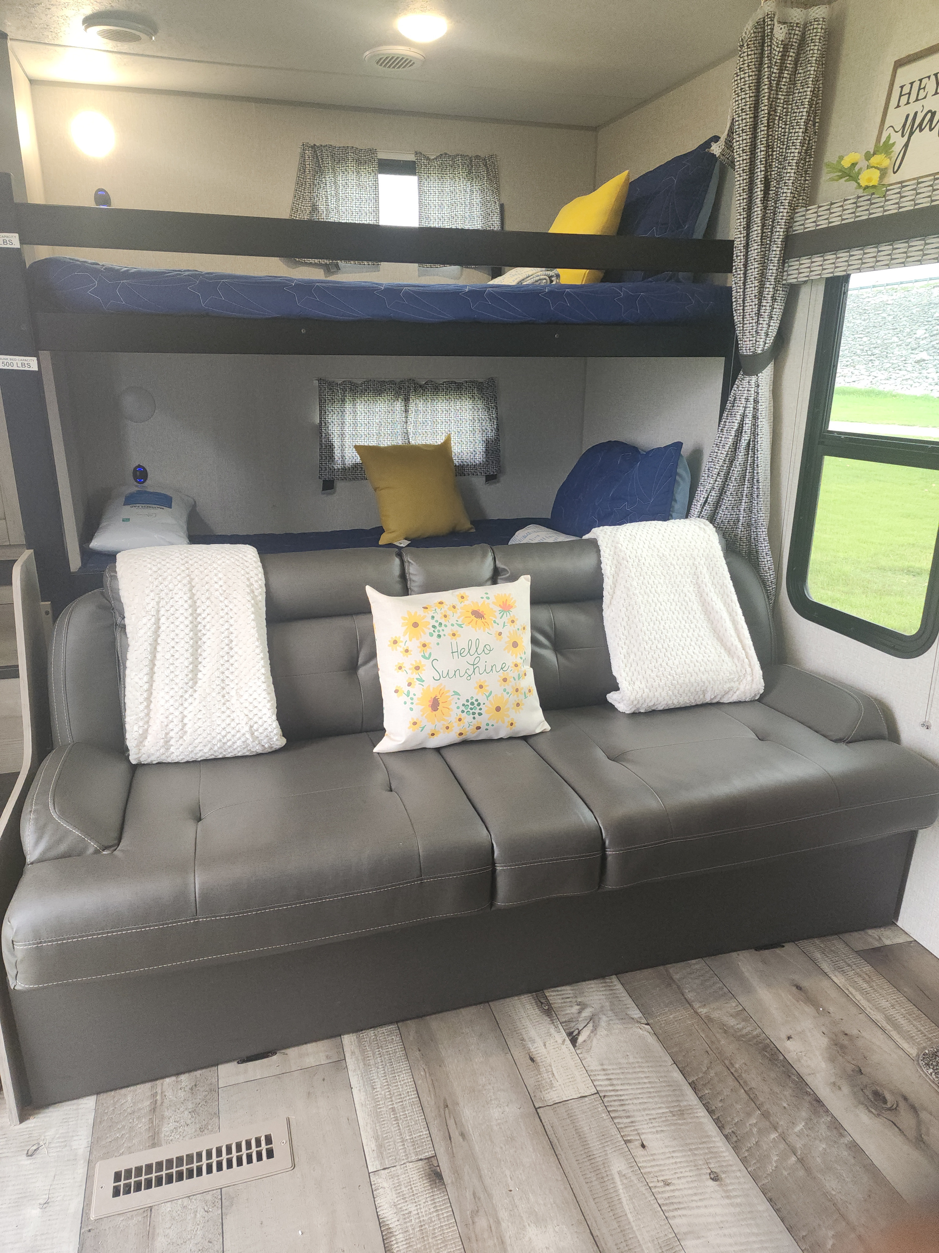 Cozy RV rental interior with bunk beds, a comfortable sofa, and bright decor. Perfect for family adventures.. Connect C-281BHSE 2022