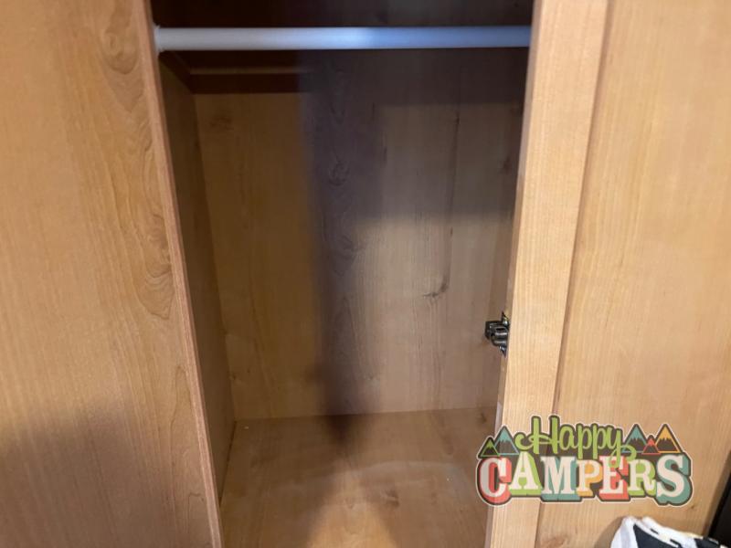 Empty light wood closet with hanging rod in an RV rental.. Old School 820FTG 2023