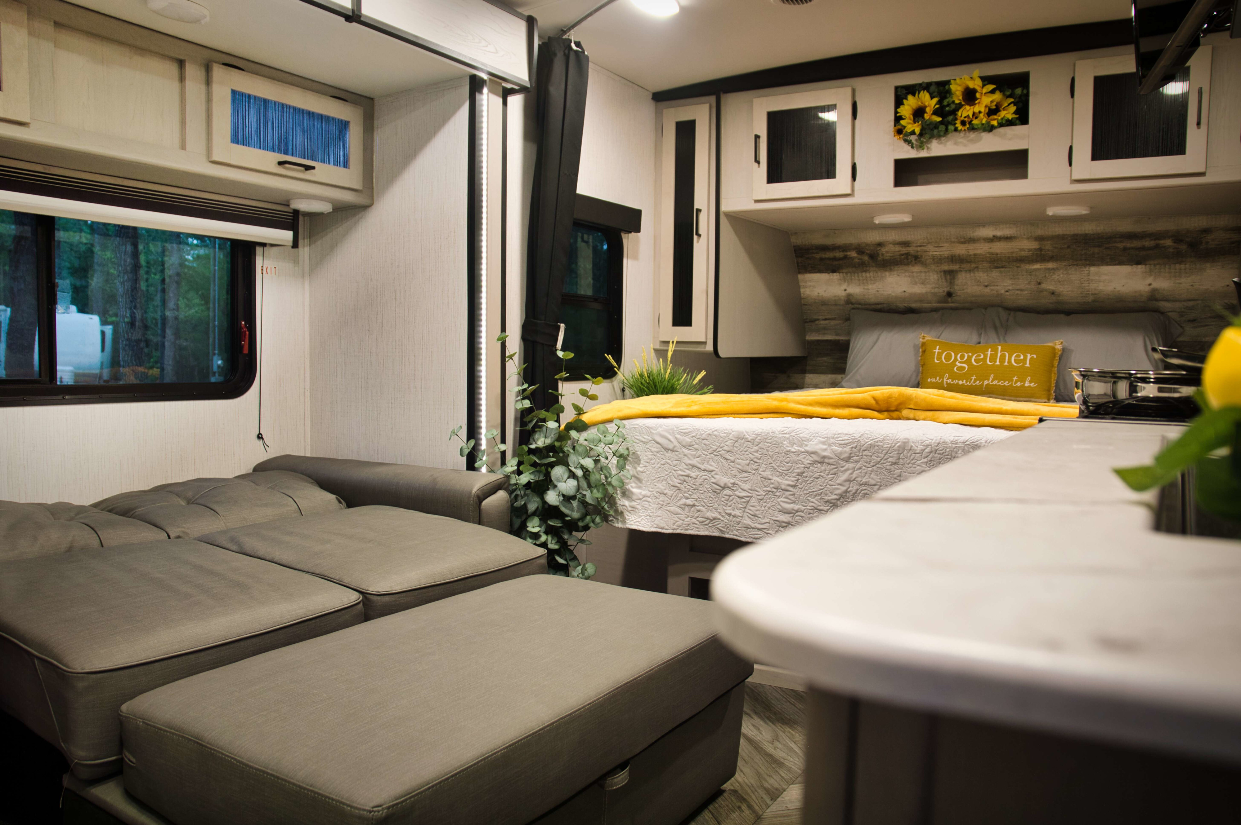 Cozy RV rental interior with convertible sofa, bed, and modern cabinets, ready for adventure.. Heartland Mallard 2023