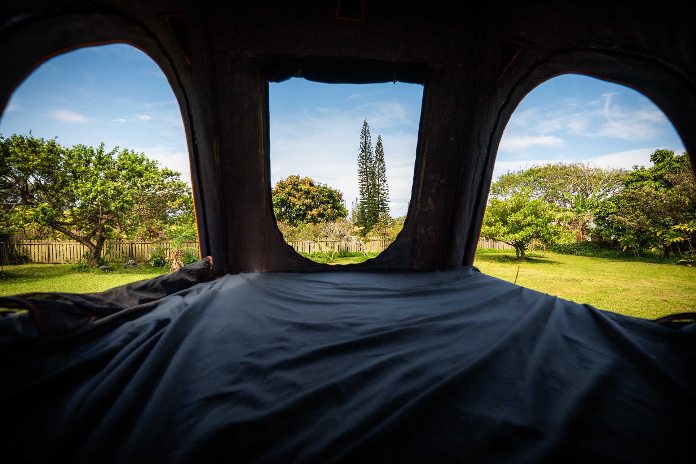 From inside a comfortable RV rental, enjoy the view of a lush green yard, tall trees, and clear blue sky through arched openings.. Toyota FJ Cruiser 2007