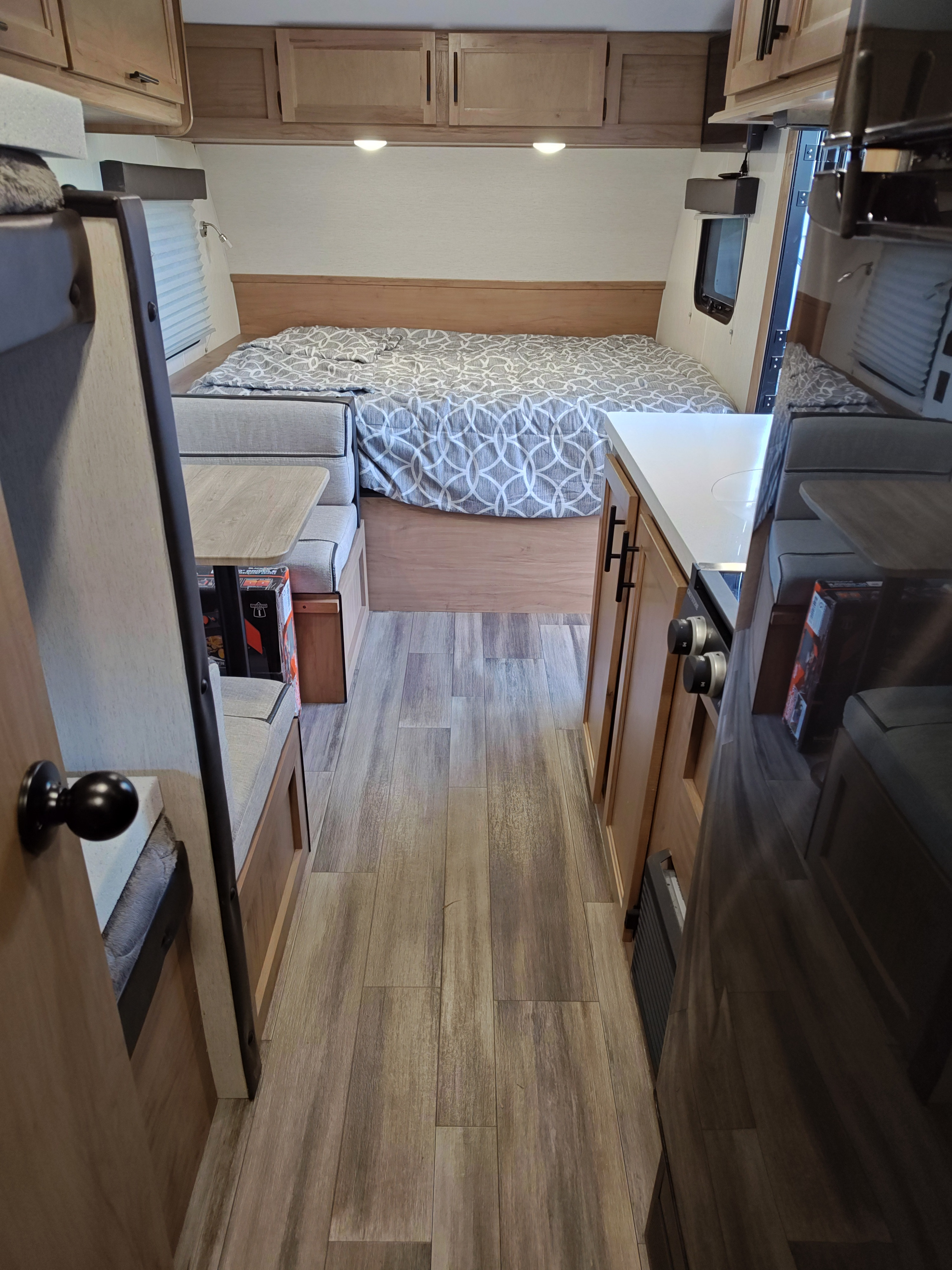 RV rental: Bright interior with a cozy bed, dinette, and compact kitchen. Features LVP flooring and overhead storage.. Forest River Cherokee Cherokee Black Label Series 2023