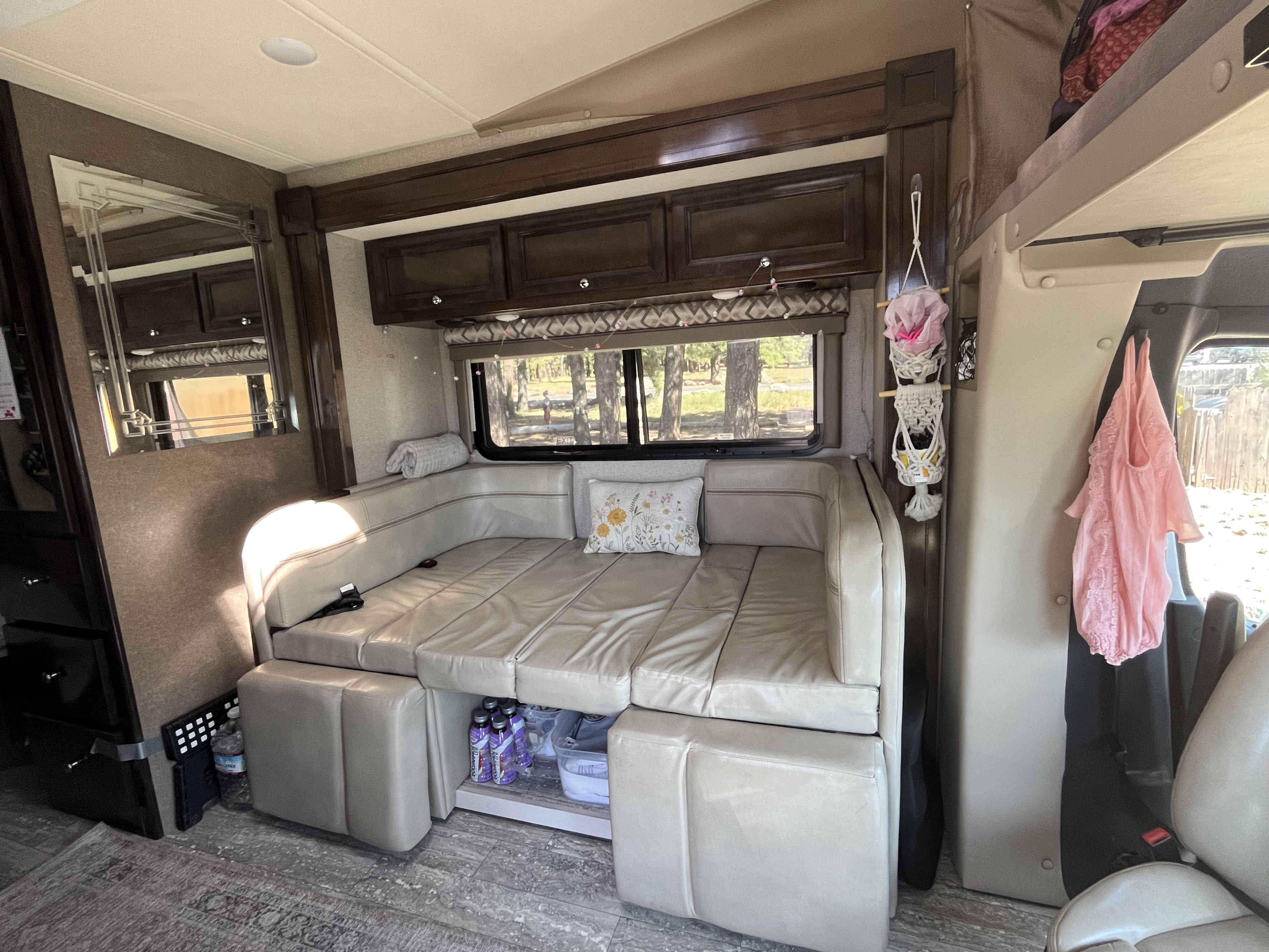 Experience comfortable **rv rental** travel with this cozy interior, featuring a U-shaped dinette that converts into a sofa bed, plus scenic window views.. Thor Siesta 2020