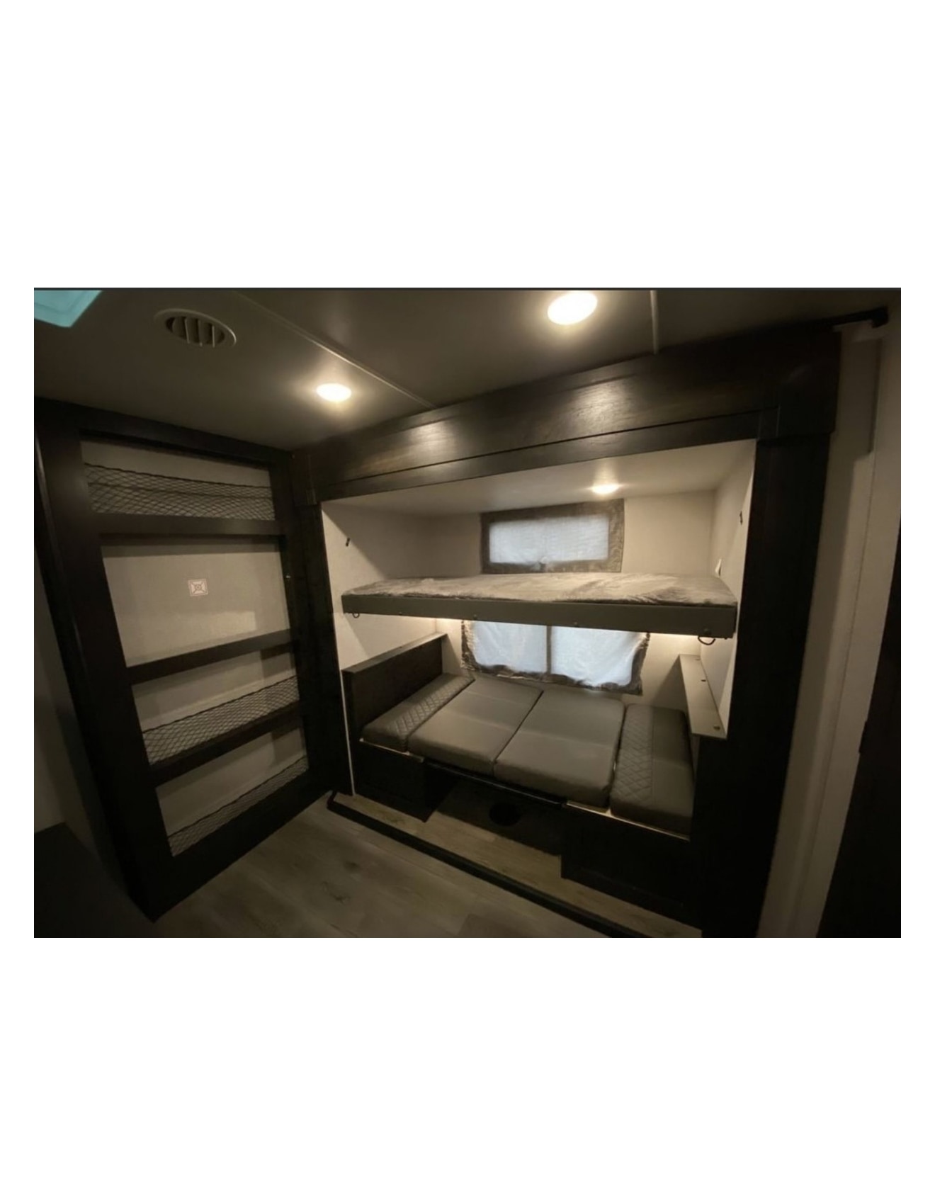RV rental with a functional bunk room: upper bunk, convertible lower bed, & mesh storage shelves. Ideal for families.. Highland Ridge RV Open Range 2021